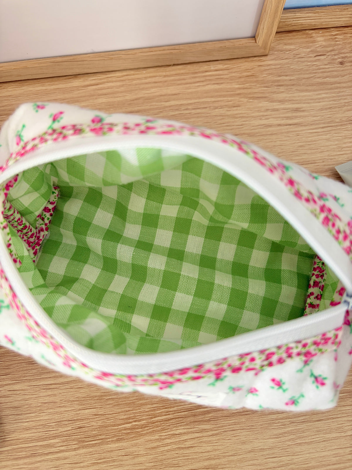 Mini rose print zip pouch bag interior with green gingham lining and white zipper trim