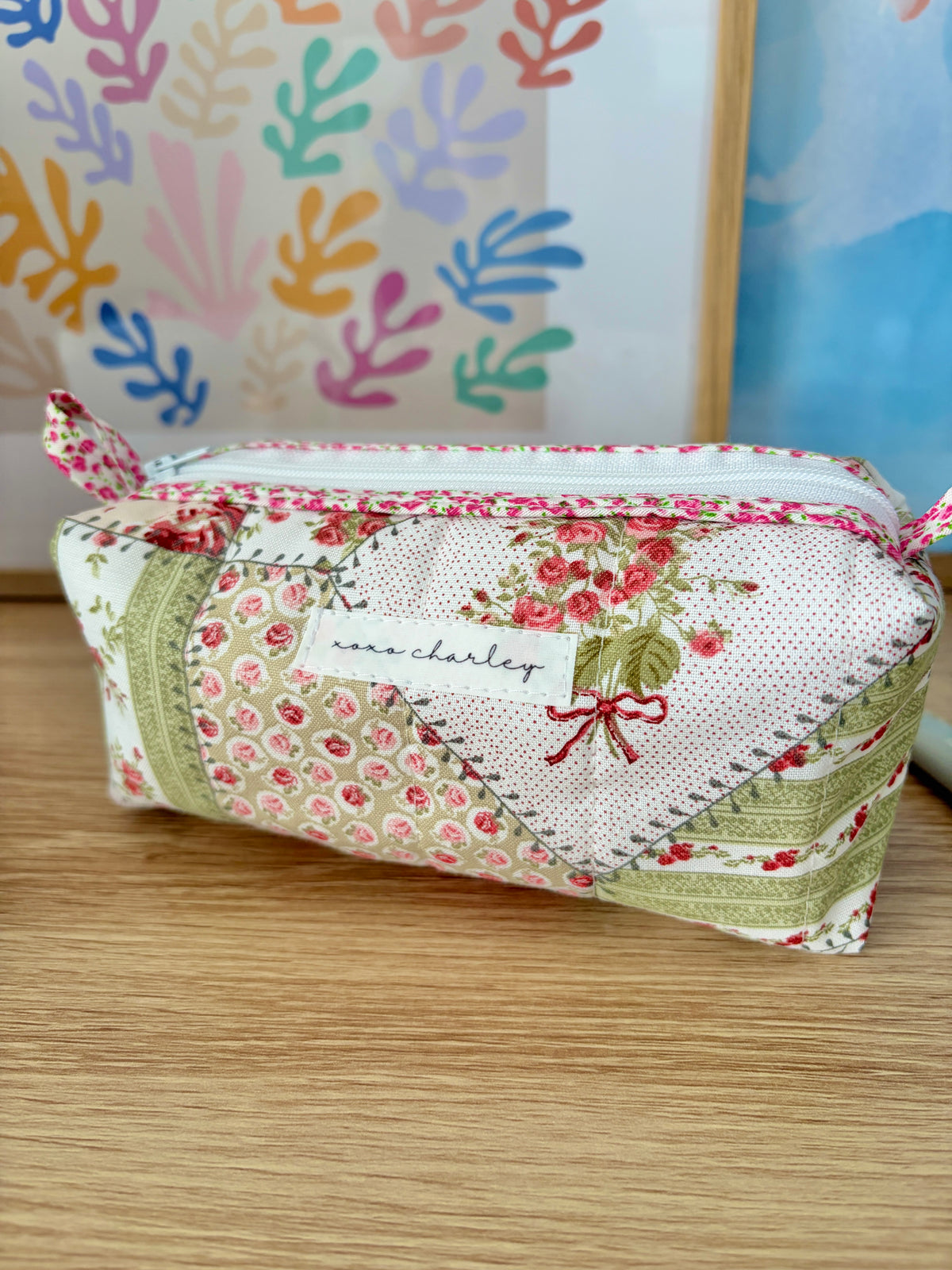 Pink floral and white colorblock handbag with “marchalier” front patch and bow