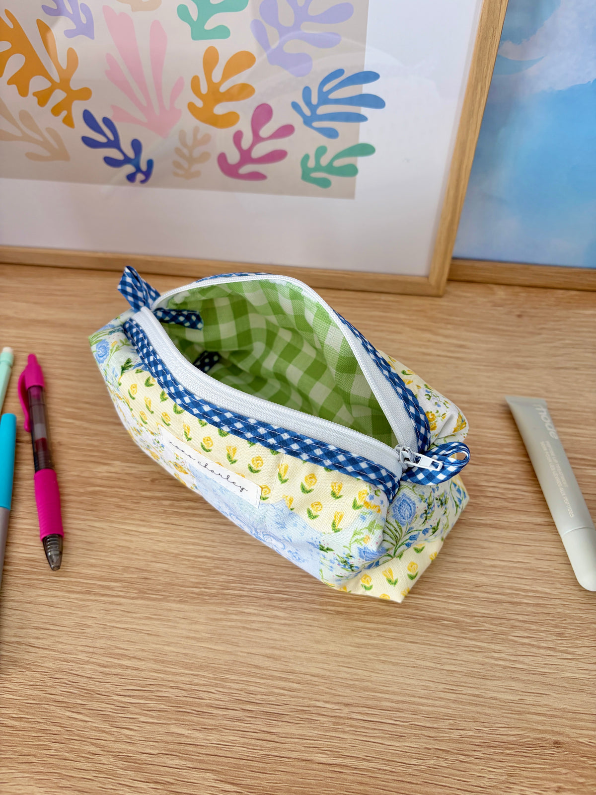 Open patchwork zip pouch with green gingham lining and blue gingham trim