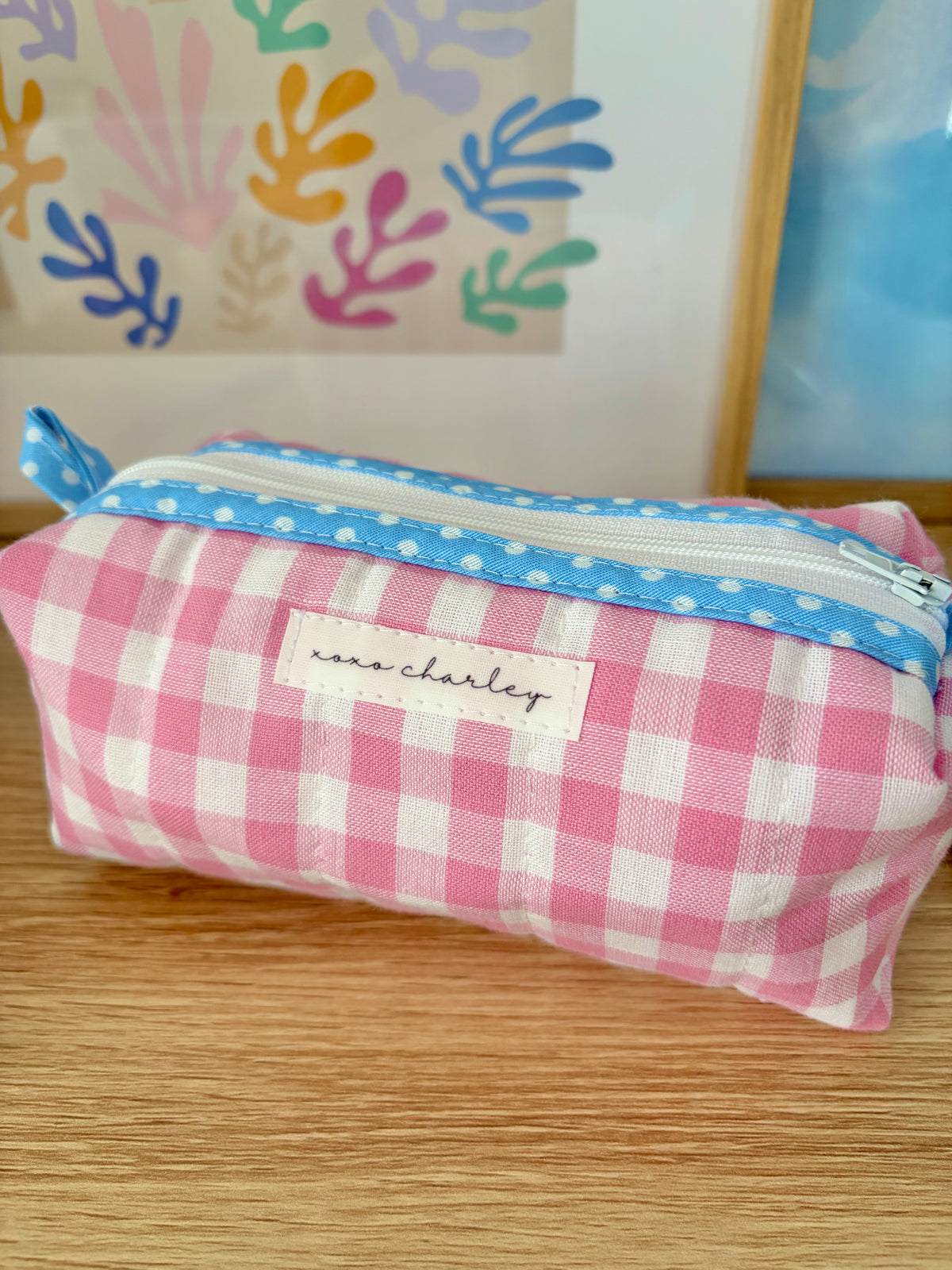 Pink gingham pouch with blue trim; Jane Charley label on front panel.