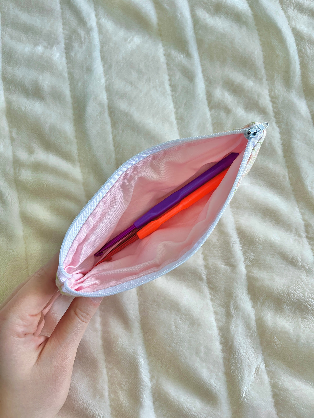 Floral pencil and glasses case pouch with pink lining and zipper, held open