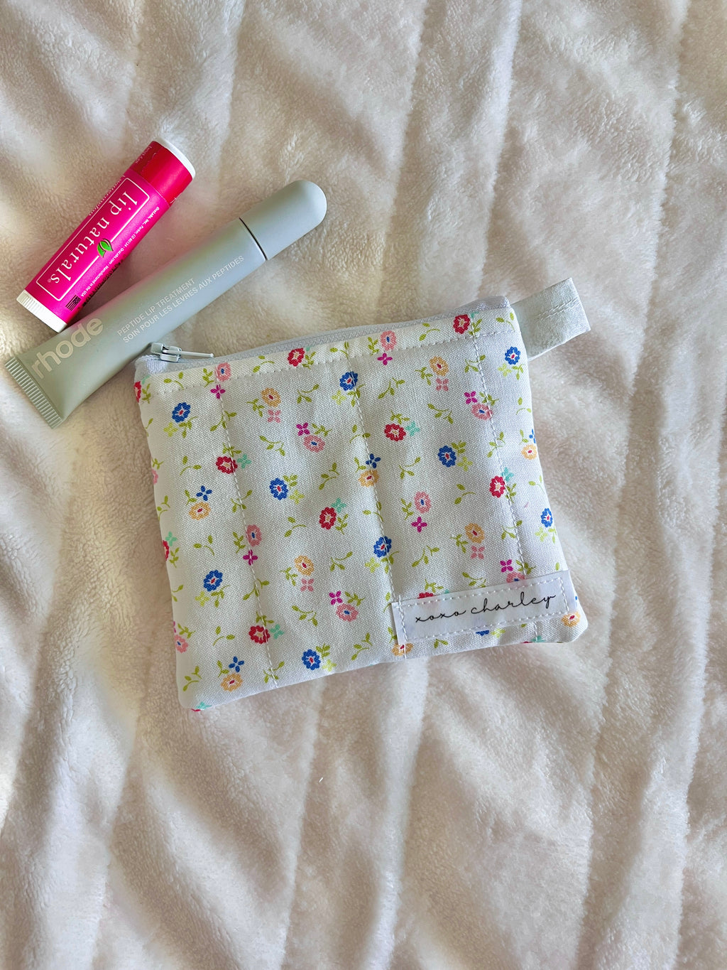 Floral keychain wallet pouch, folded and closed with ribbon strap