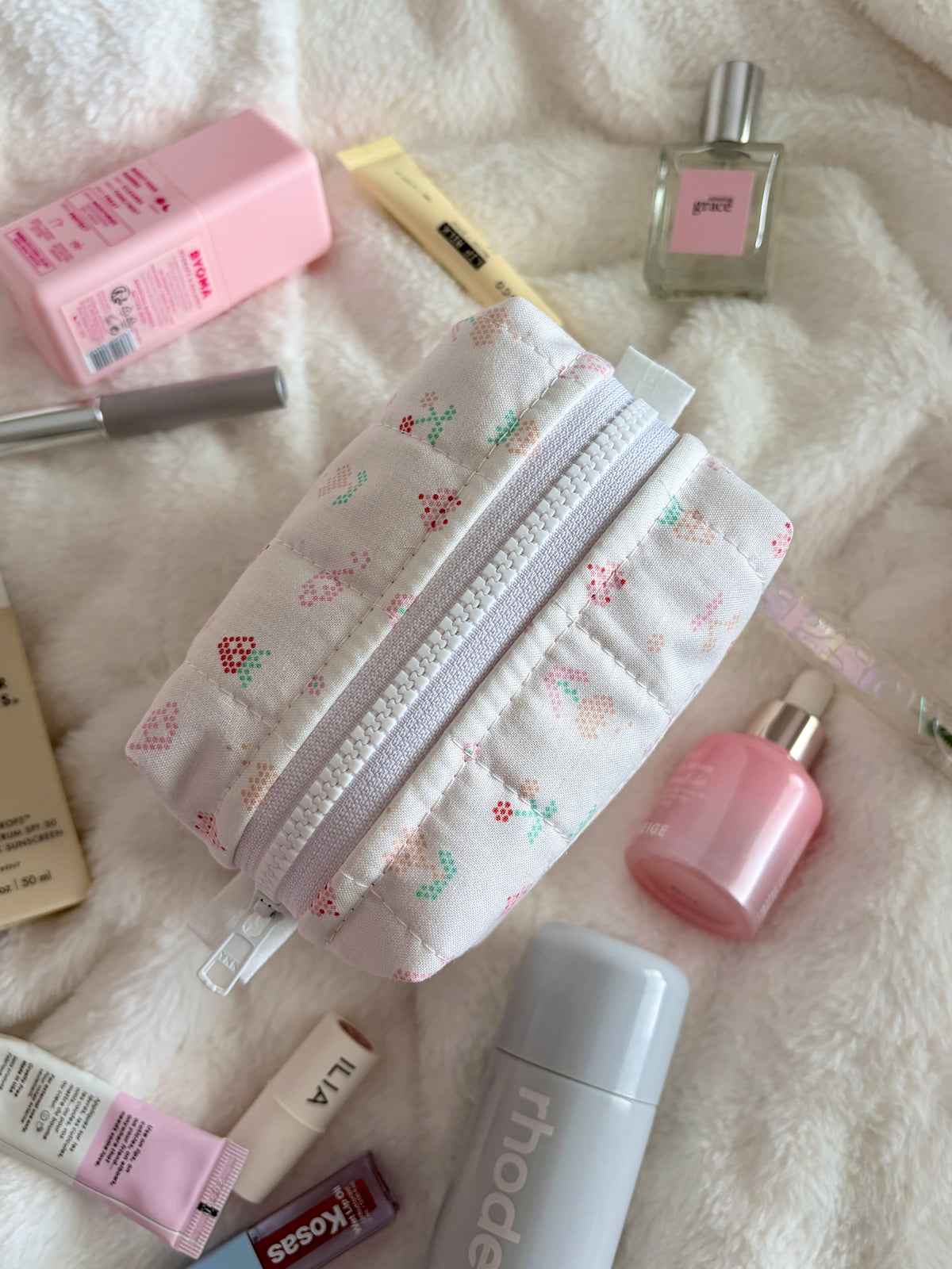 Pixel Picnic mini makeup bag with multicolor pixel print and silver zipper, side view
