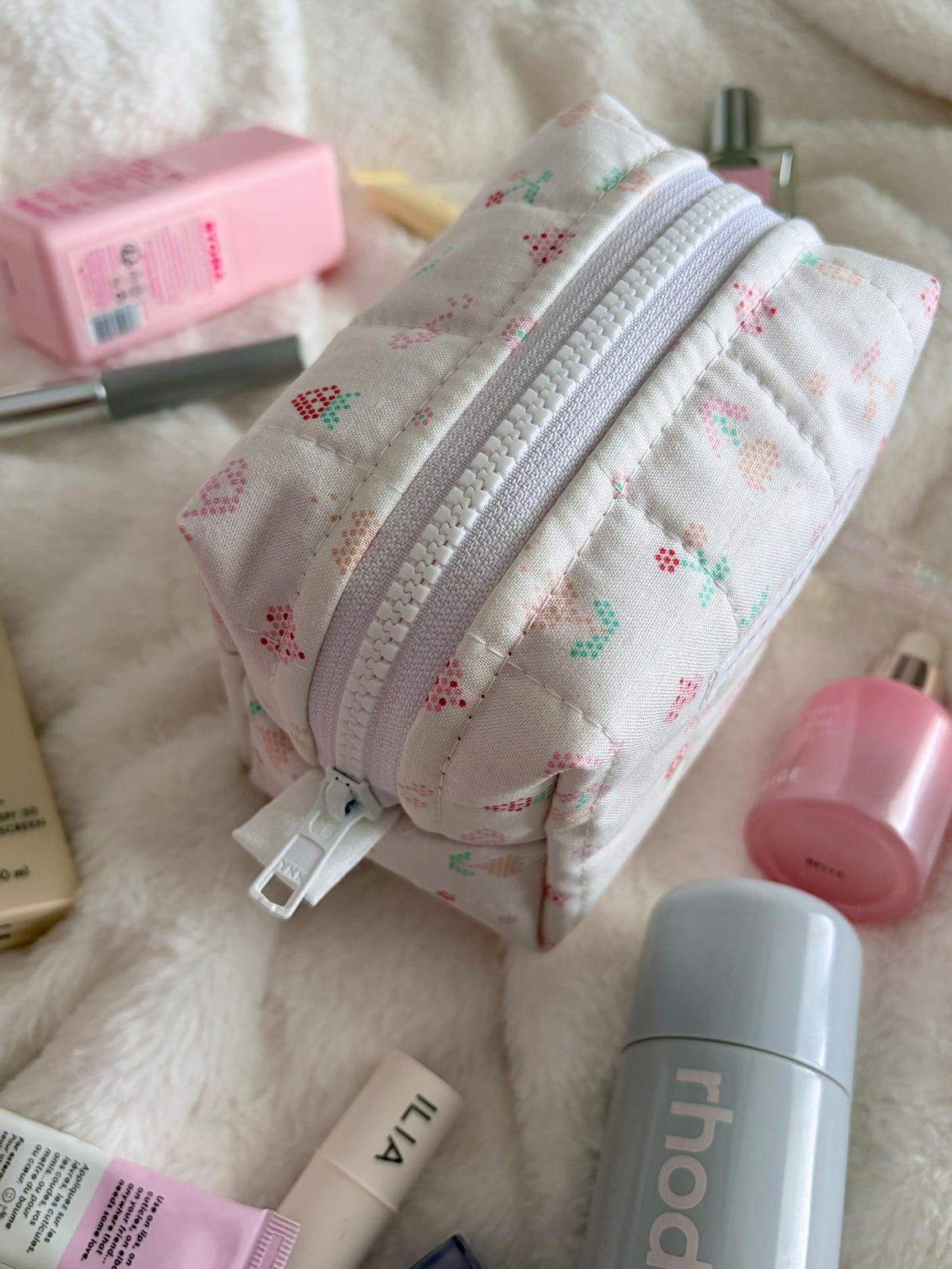 Pixel Picnic mini makeup bag with white multicolor pixel pattern and curved zipper pocket