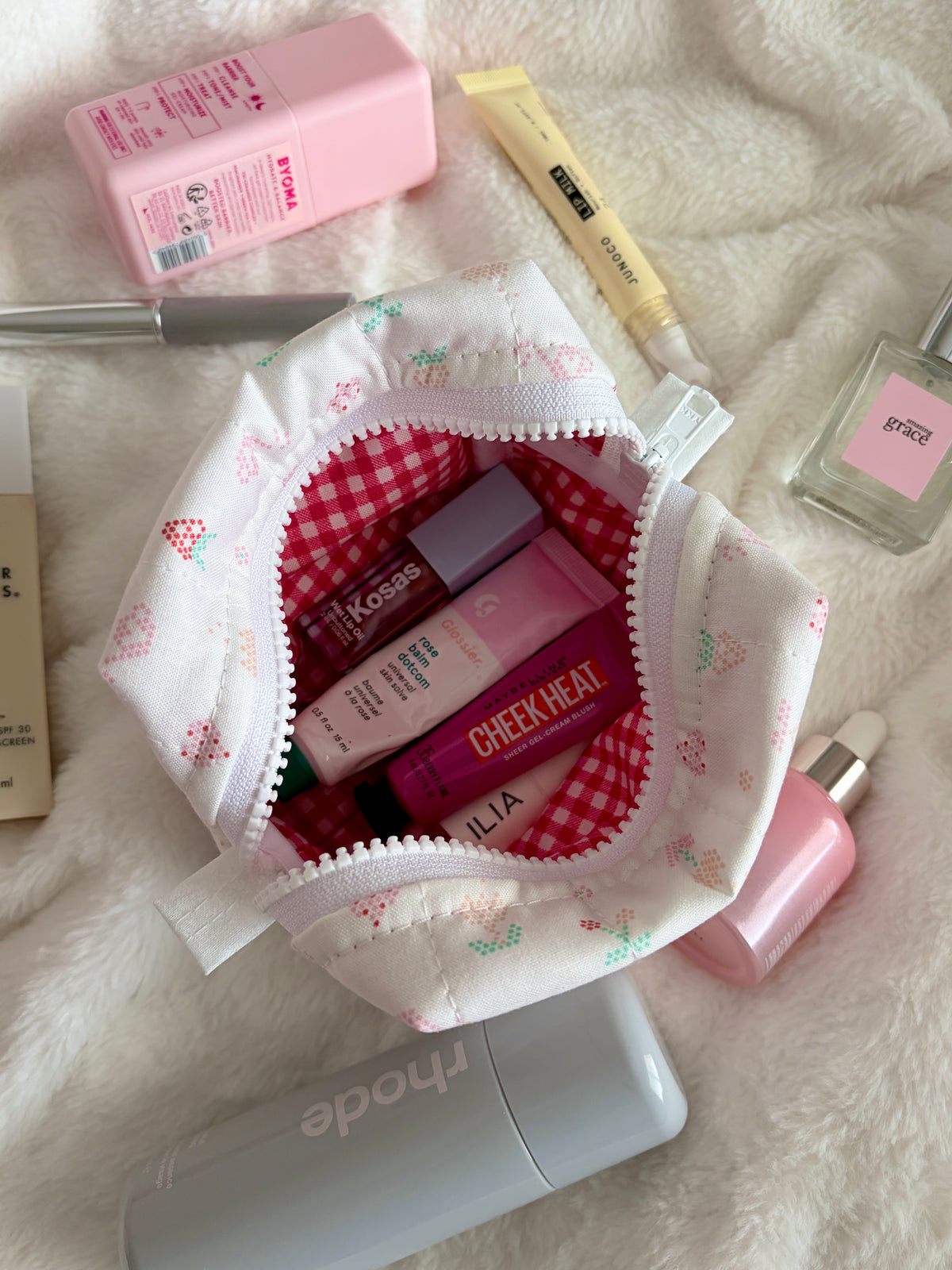 Pixel Picnic mini makeup bag open top with red gingham lining and pixel-print exterior