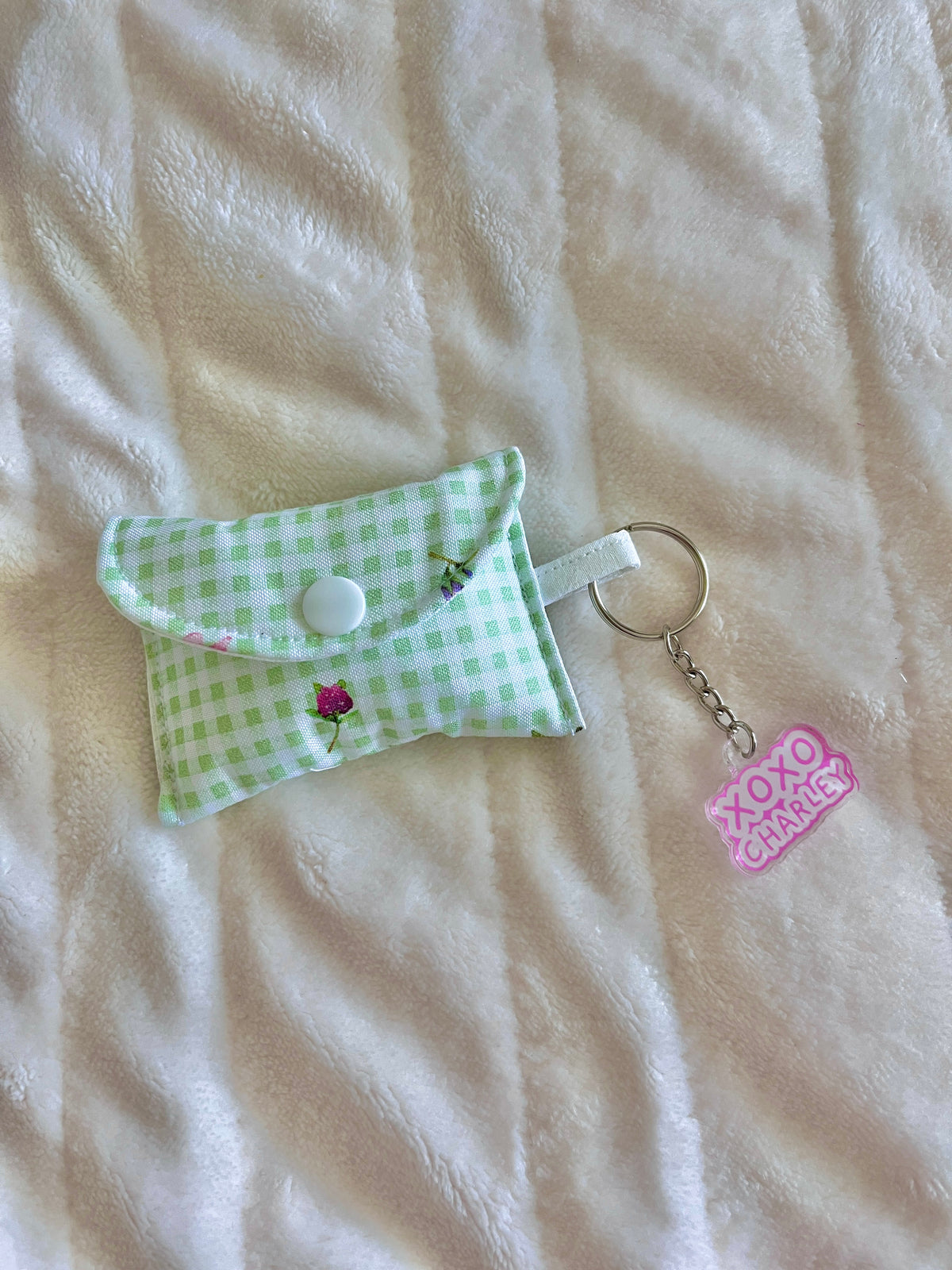 Eden earbuds case with green gingham fabric, snap tab and XO Charley keychain charm