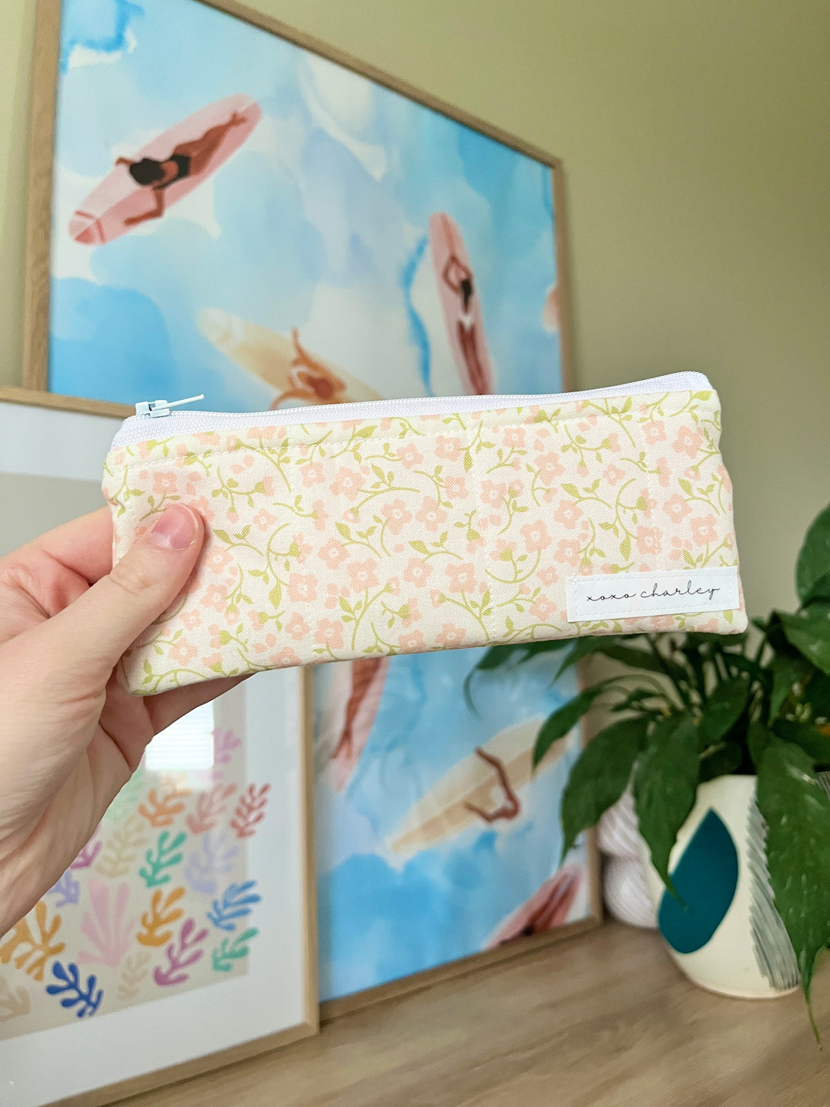 Floral zippered pencil and glasses case pouch, held in hand