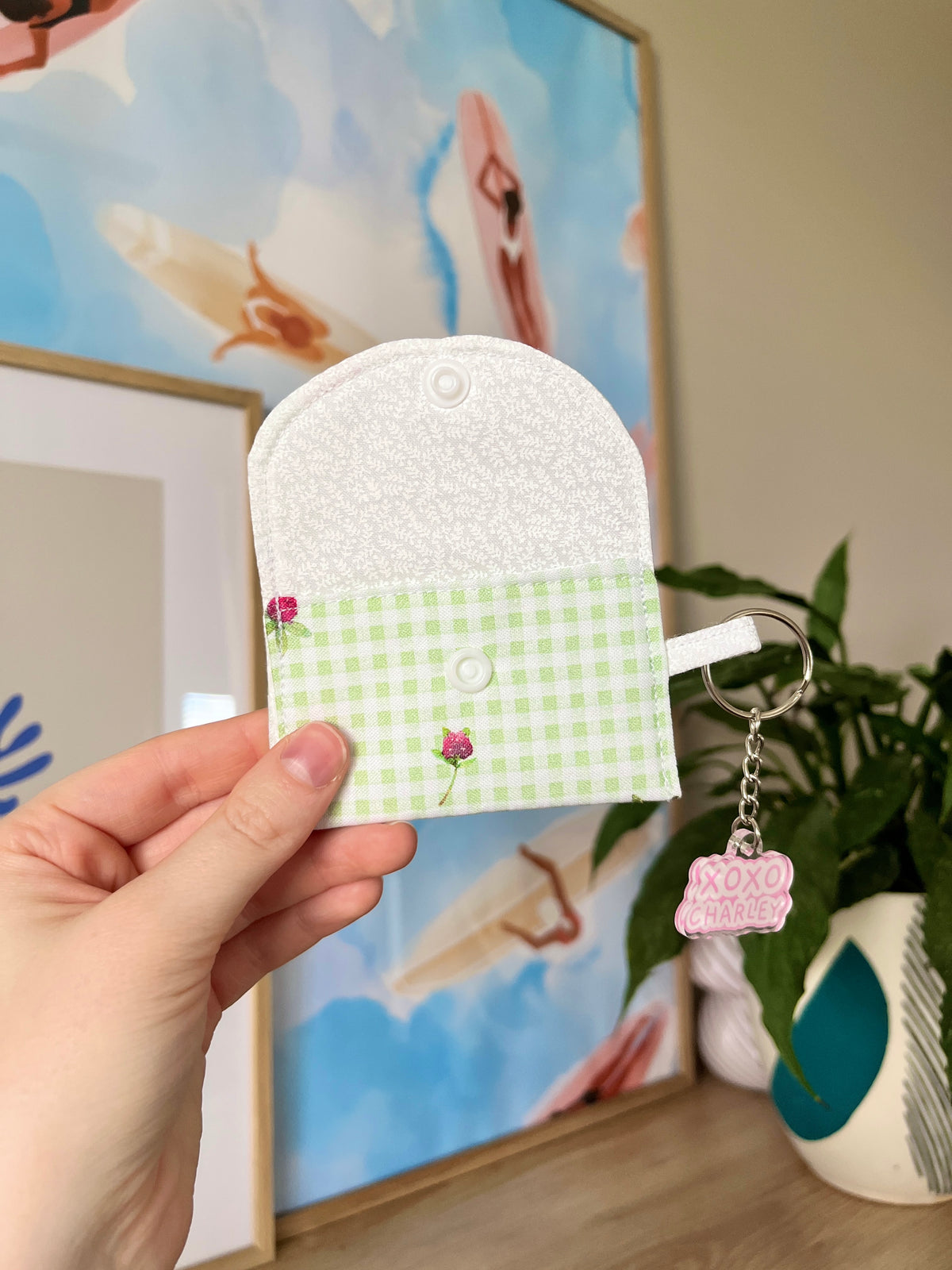 Eden earbuds case with green gingham front, floral patch, snap button and keyring