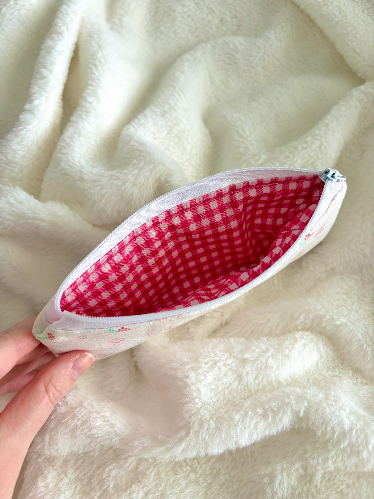 Pencil and glasses case with red gingham lining and zipper, shown open