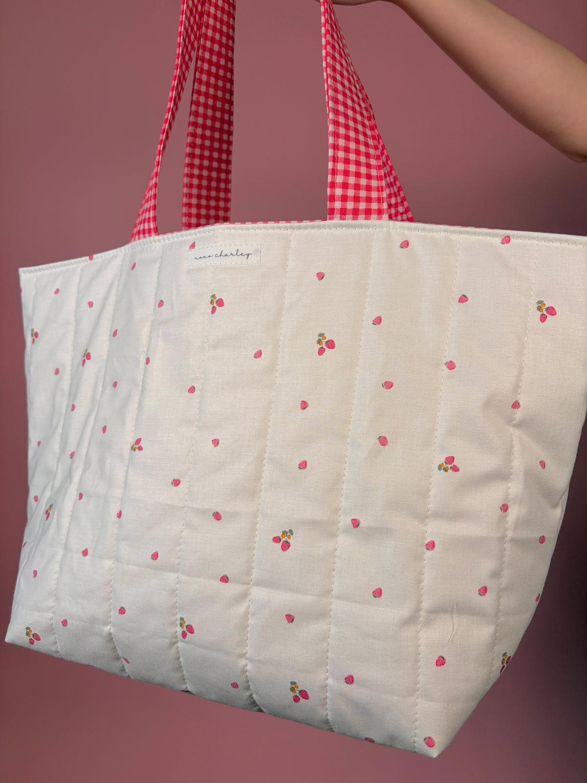Large canvas tote bag in white with berry flower print and red gingham handle straps