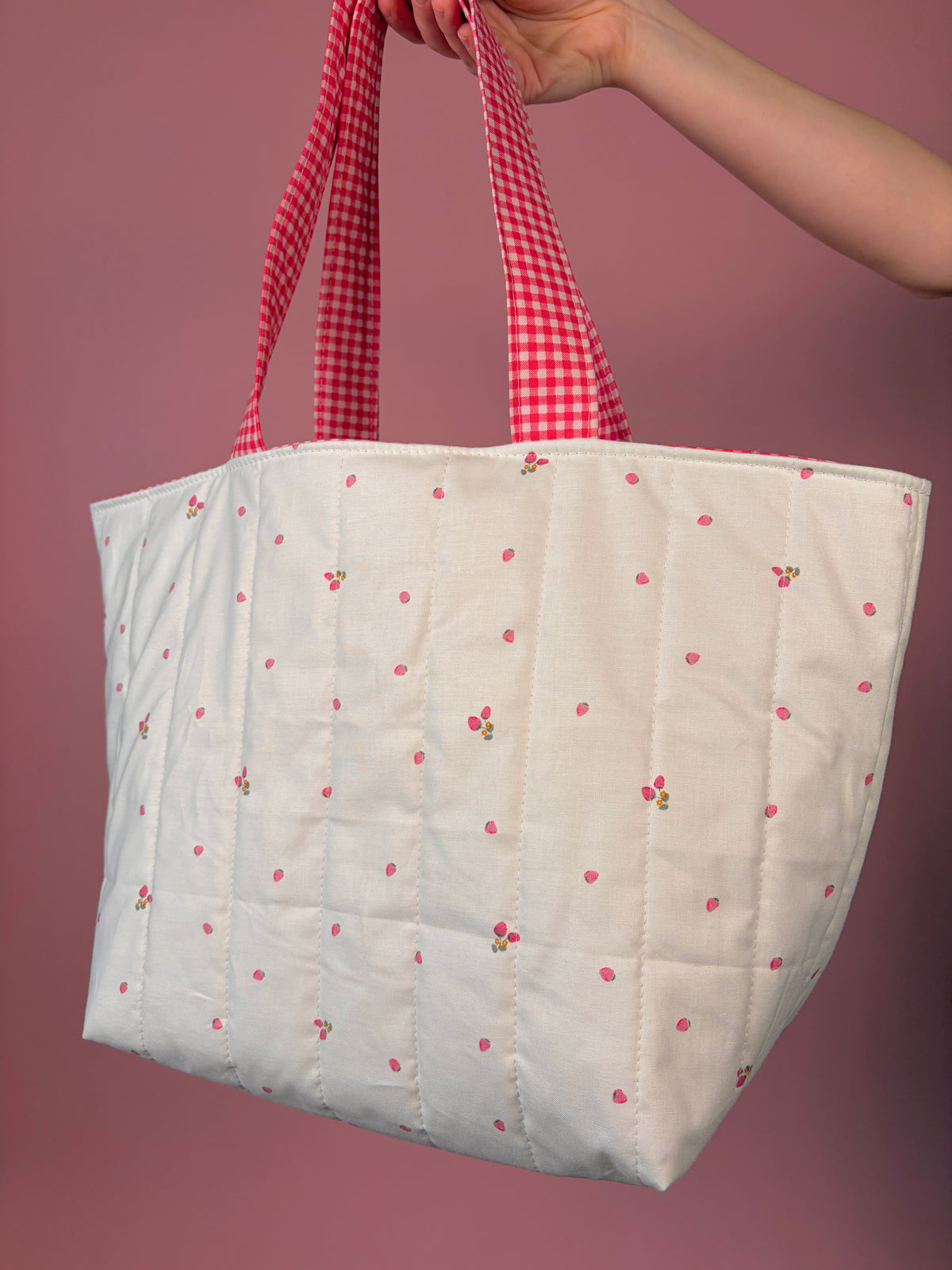 Large white tote bag with berry flower print and red gingham handles, roomy quilted shape