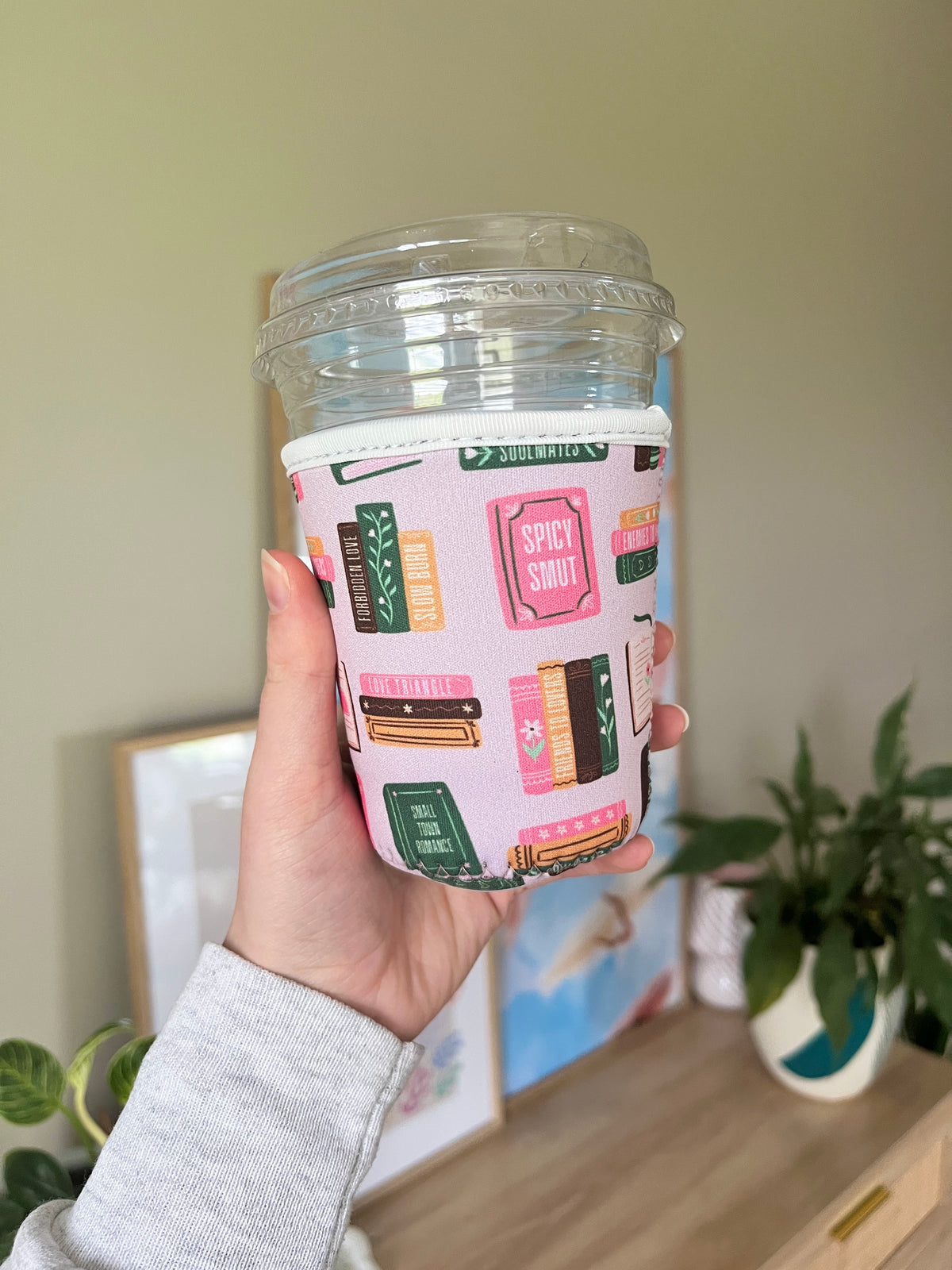 Printed cup sleeve for a plastic cup, colorful book-cover pattern