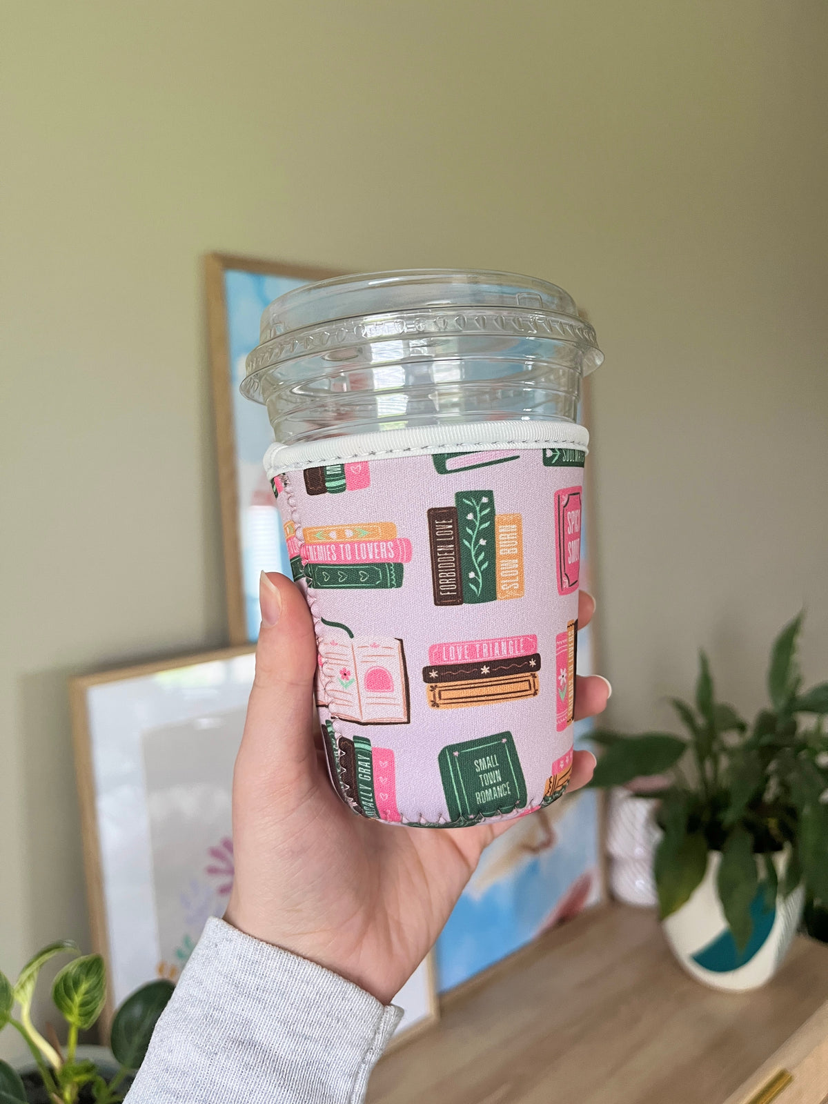 Printed cup sleeve for a plastic cup, colorful book-cover pattern