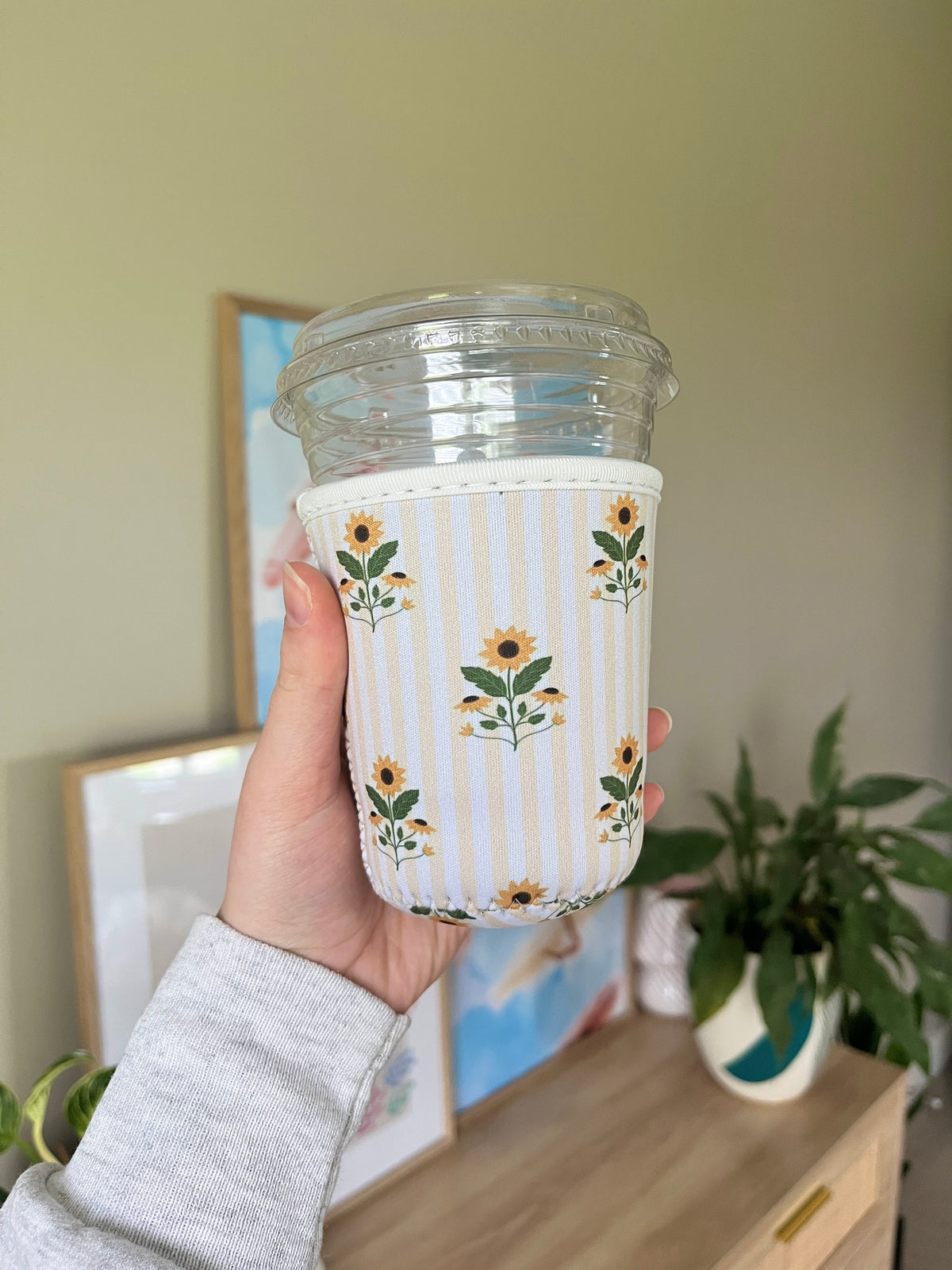 Sunflower cup sleeve with blue-and-white stripes and floral border, cup shown