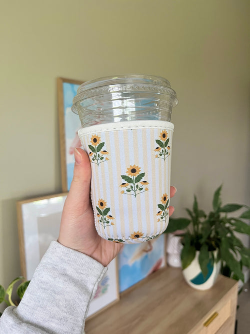 Sunflower cup sleeve with blue-and-white stripes and floral border, cup shown
