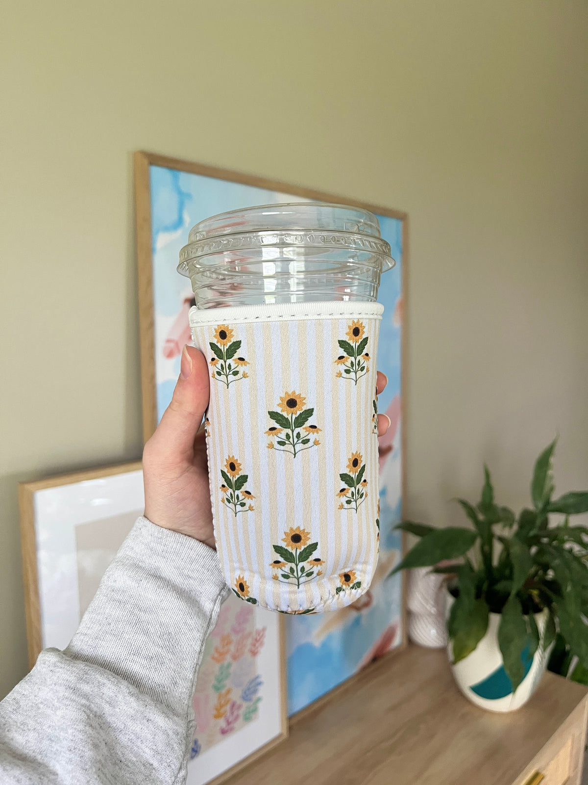 Sunflower cup sleeve with vertical stripes and floral prints on clear cup