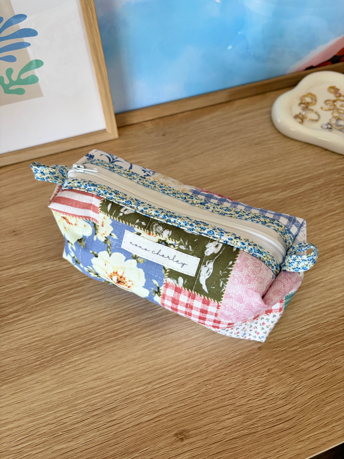 Colorblock picnic bag with blue floral trim, pink and red gingham panels, zip top