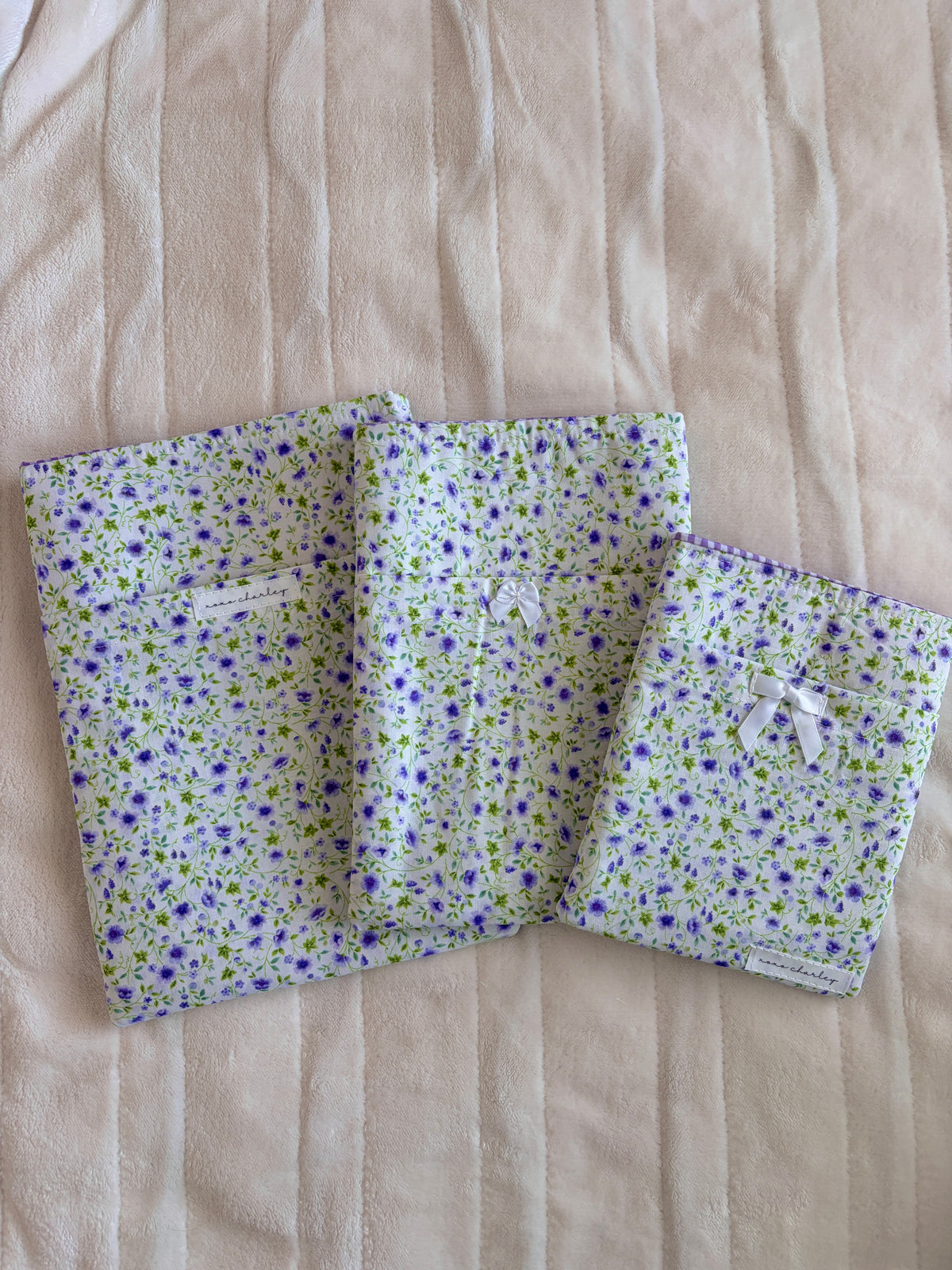 Purple floral e-reader/book sleeve with fold-over compartments, no bow visible