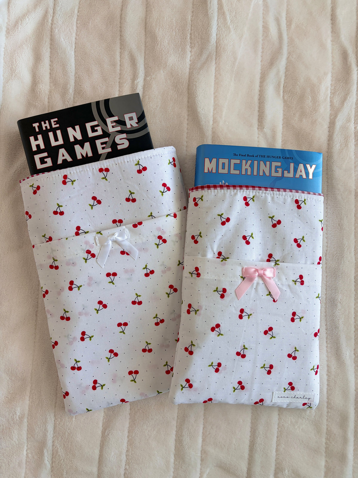 Cherry-print e-reader/book sleeve set, one with small pink bow