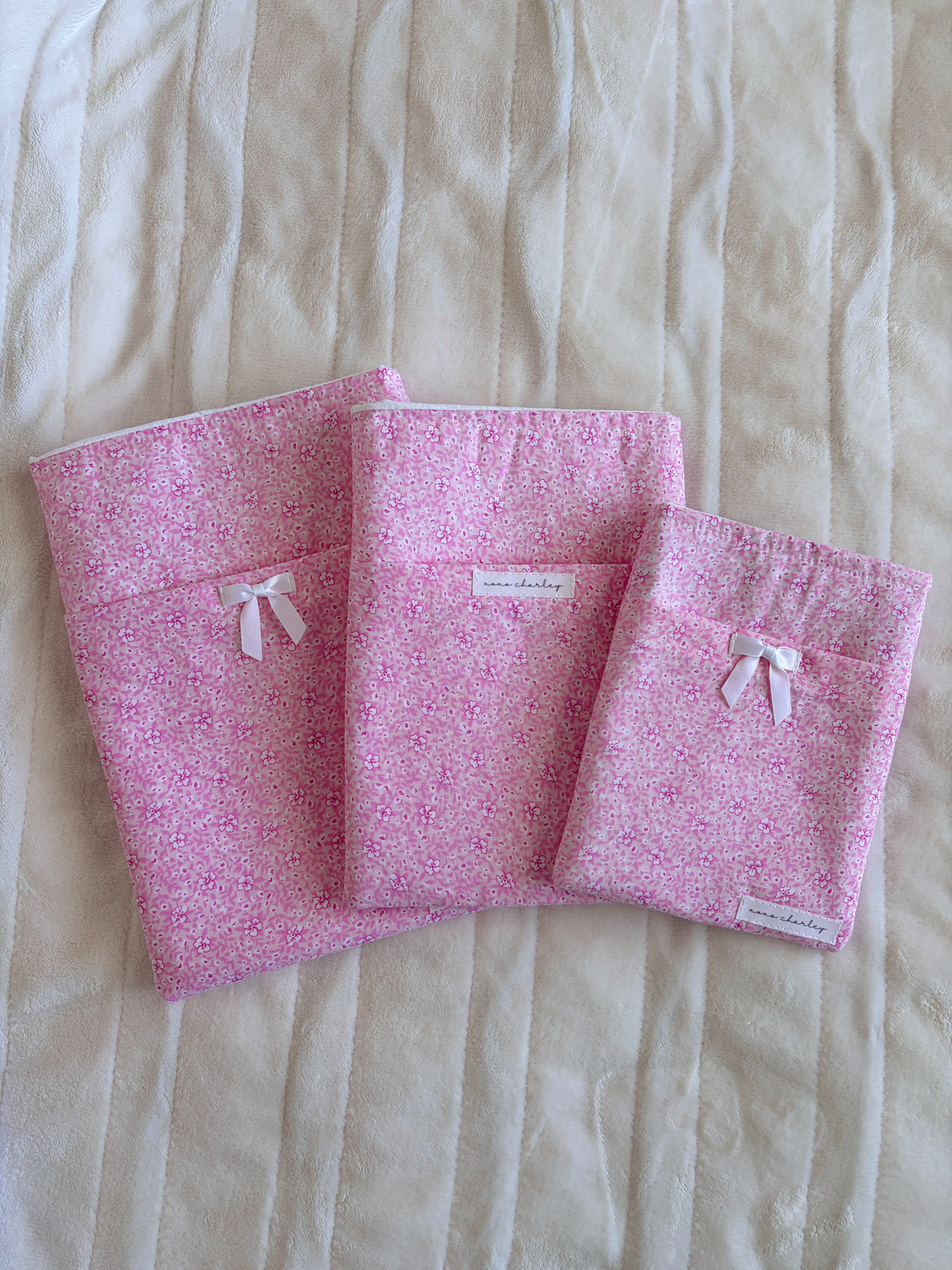 Pink floral e-reader and book sleeves, three-piece set with small white ribbon bows