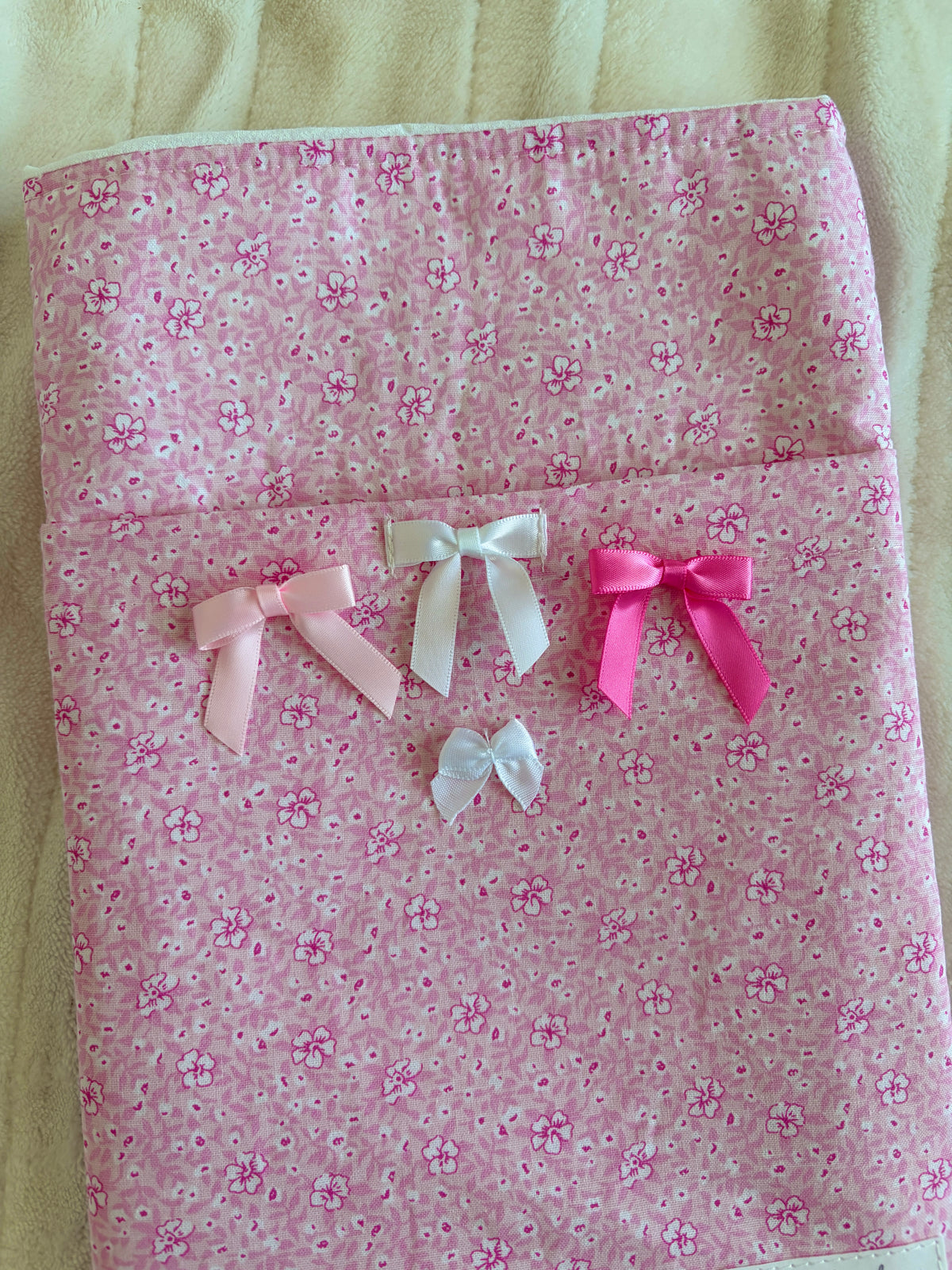 Pink floral e-reader sleeve with ribbon bow cluster, featuring white and pink bows