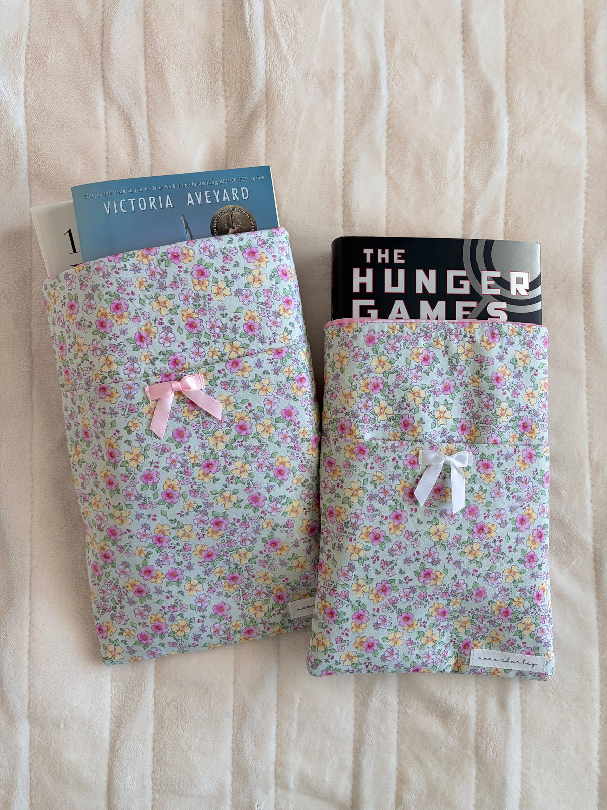 Floral e-reader/book sleeve, closed with white ribbon bow on front