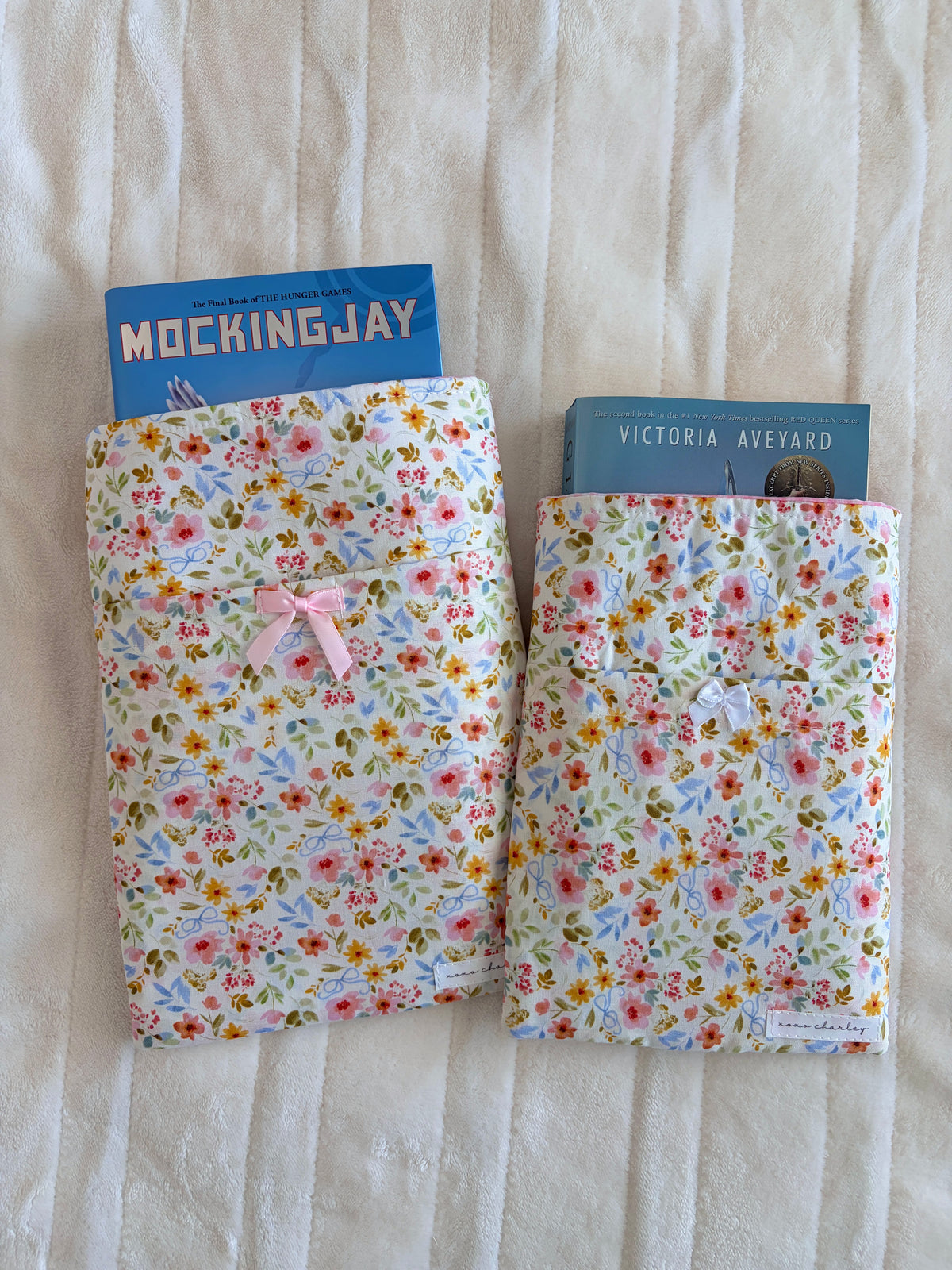 Pair of floral book/e-reader sleeves with bows on the covers