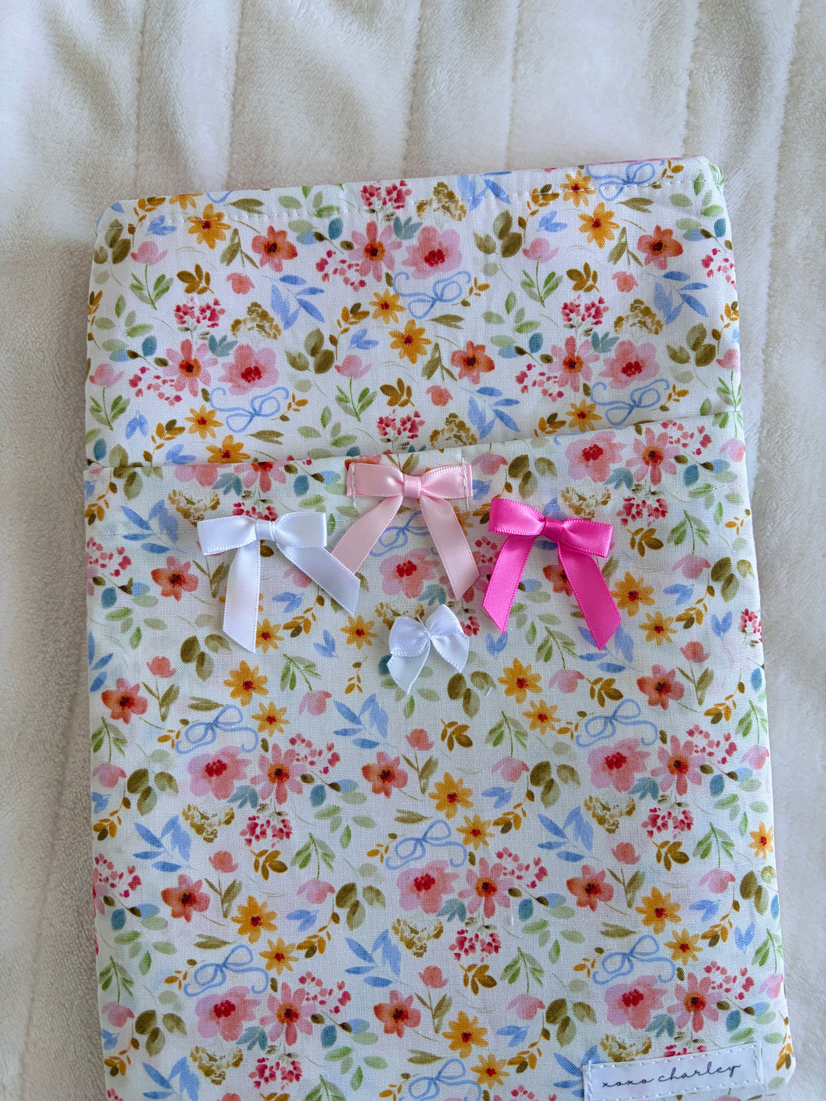 Floral e-reader/book sleeve with multiple bows and multicolor flower print