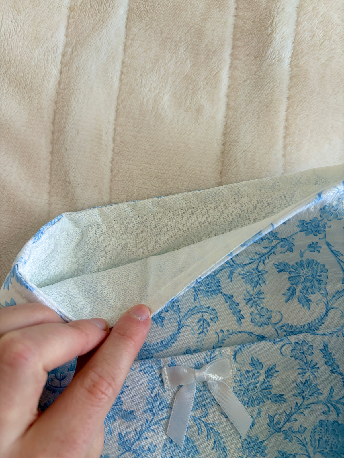 Blue floral e-reader sleeve with white bow and stitched inner lining