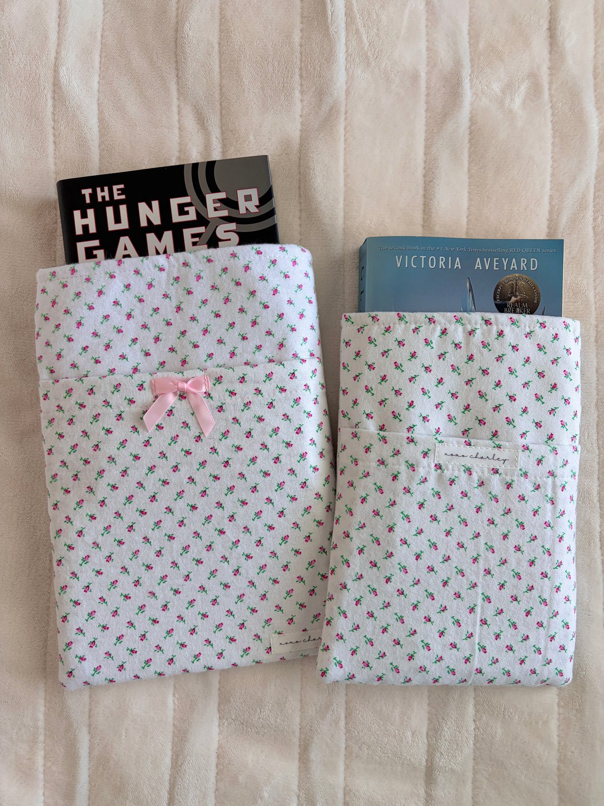 Mini rose print e-reader/book sleeve with pink bow detail on front, pouch open.