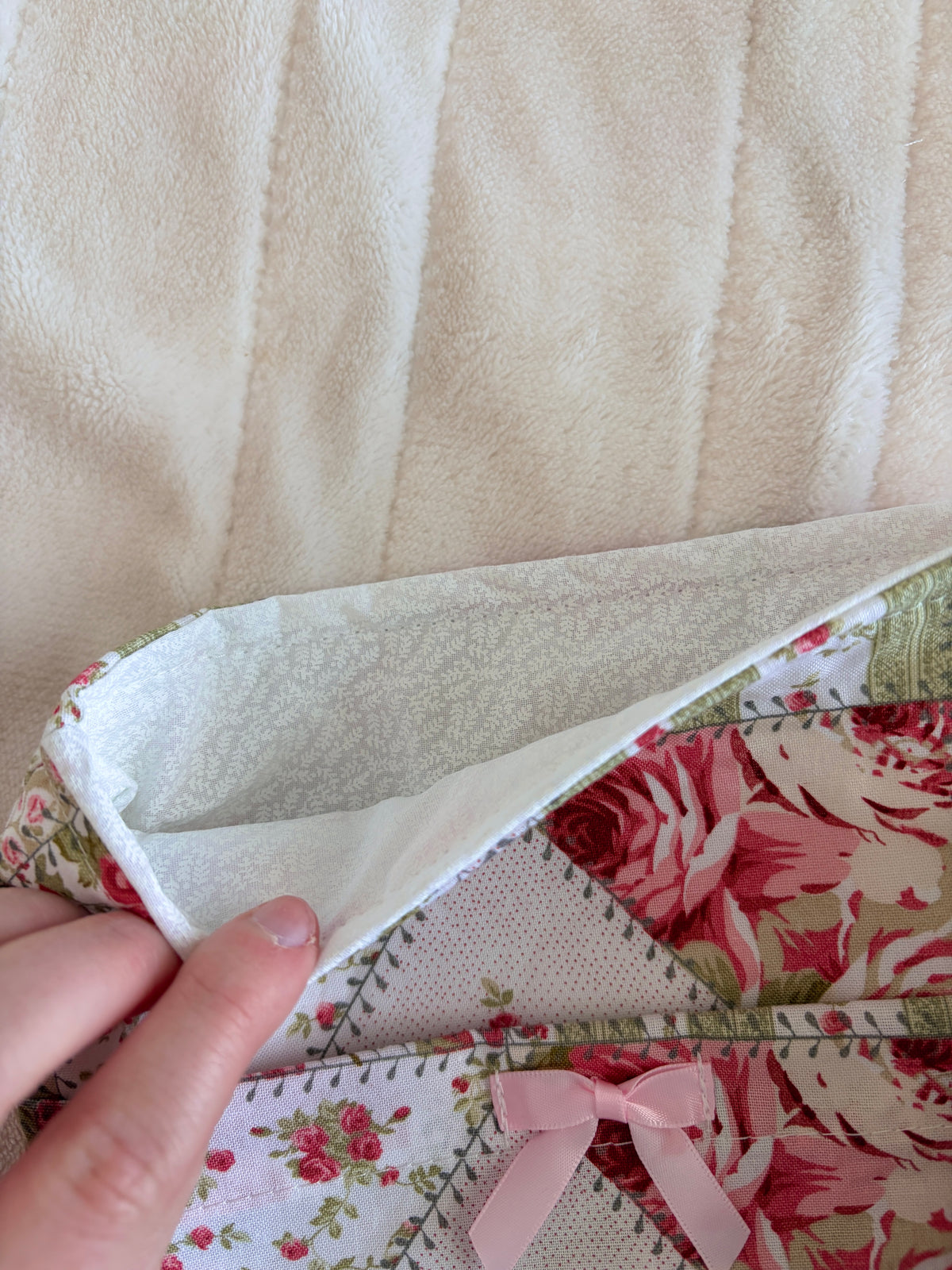 Open floral e-reader sleeve showing light interior lining and stitched patchwork