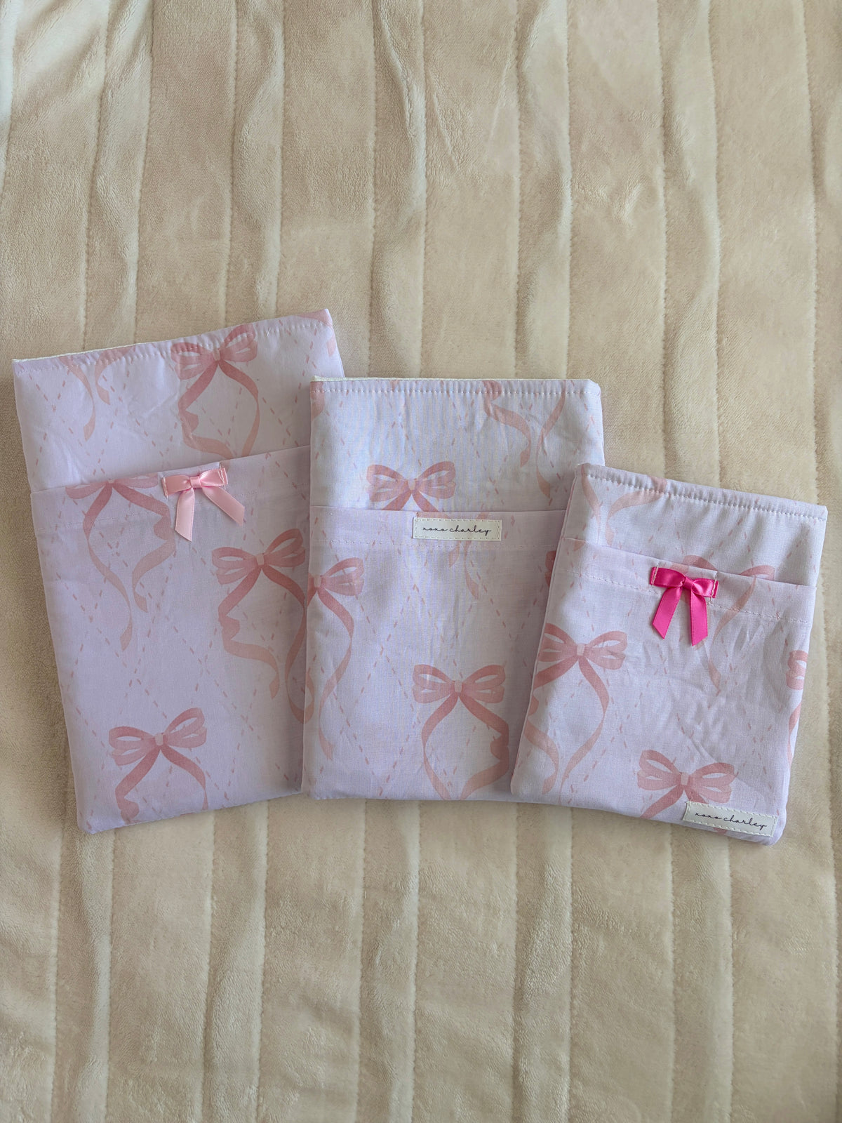 Light pink e-reader/book sleeve with bow pattern and light pink ribbon bow