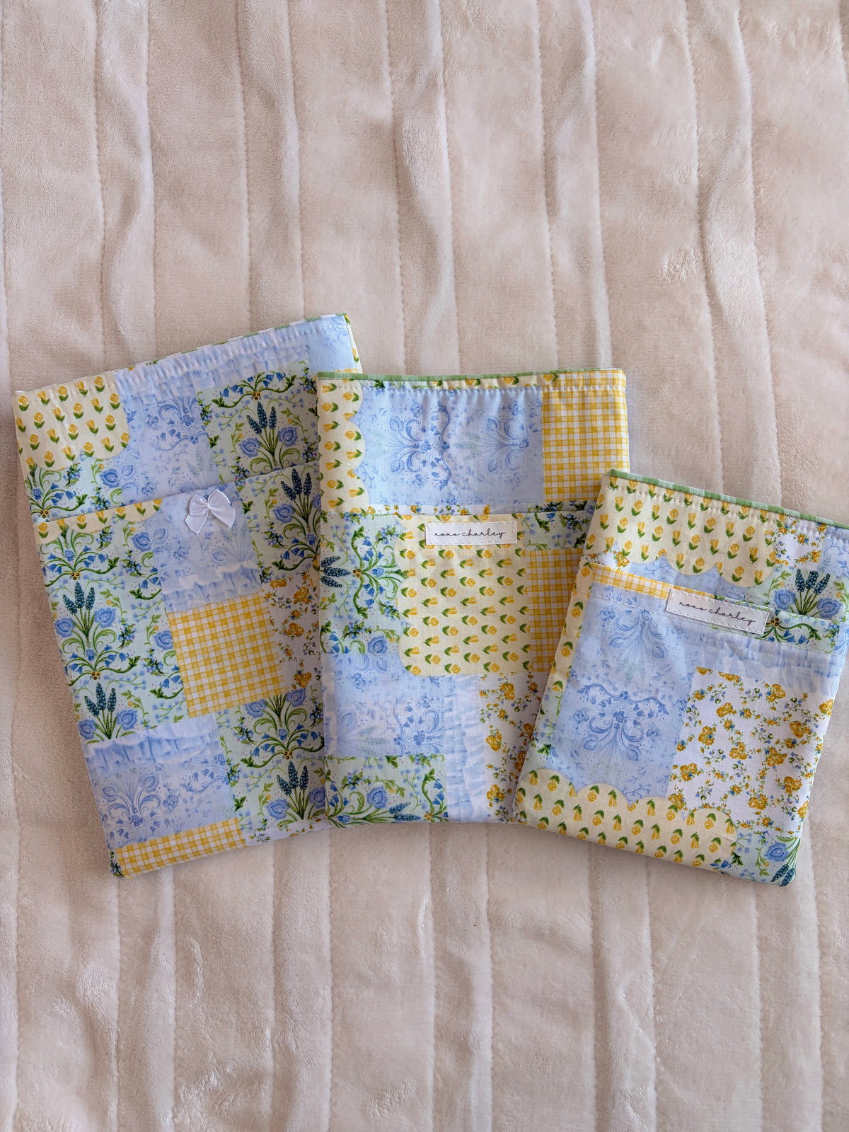 Patchwork e-reader/book sleeves with blue floral, yellow, and green gingham panels
