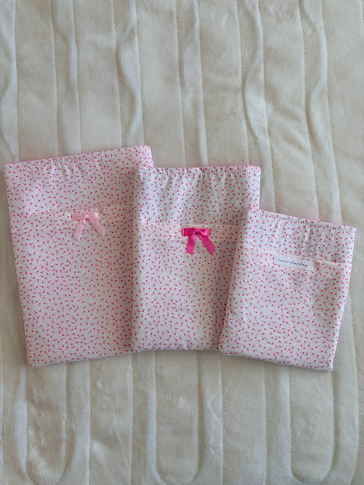 Pink tiny-heart e-reader and book sleeves, two sizes, each with light pink bow