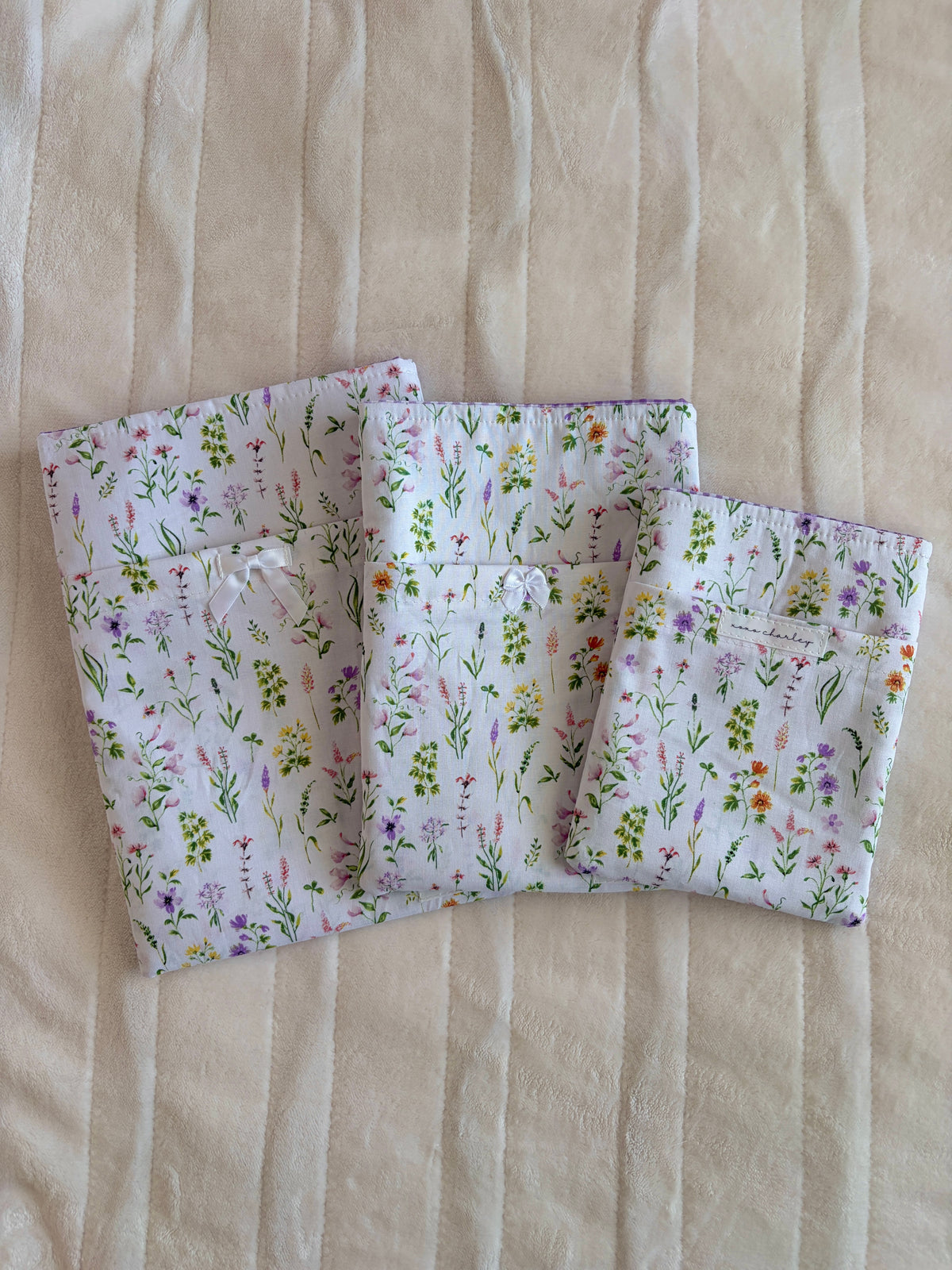 Light purple wildflower print fabric book/e-reader sleeve, open with soft structure