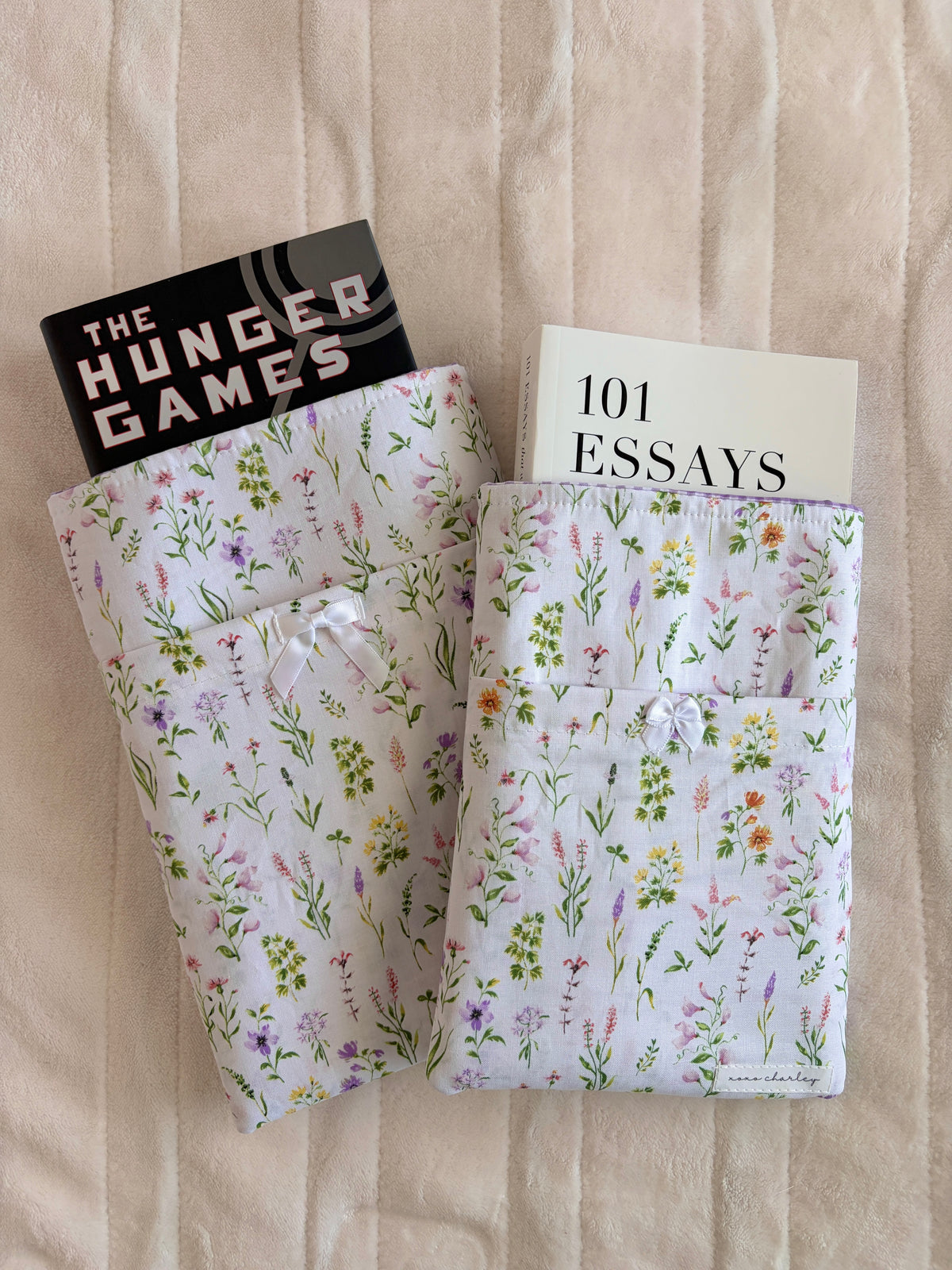 Wildflower e-reader/book sleeve holding two books with visible cover text