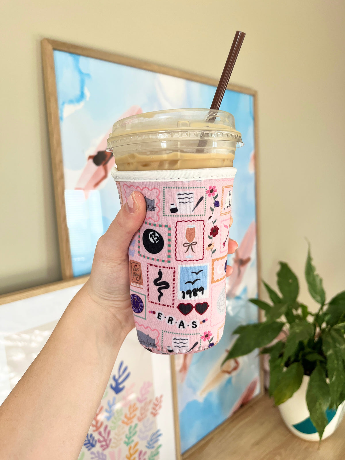 Medium patchwork cup sleeve with colorful design, fitted around cup with straw opening