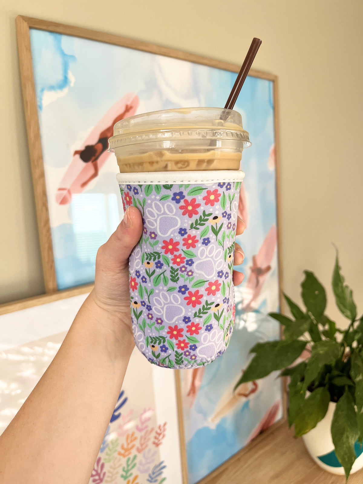 Reusable cup sleeve with floral paw print pattern, medium purple color for drink cups