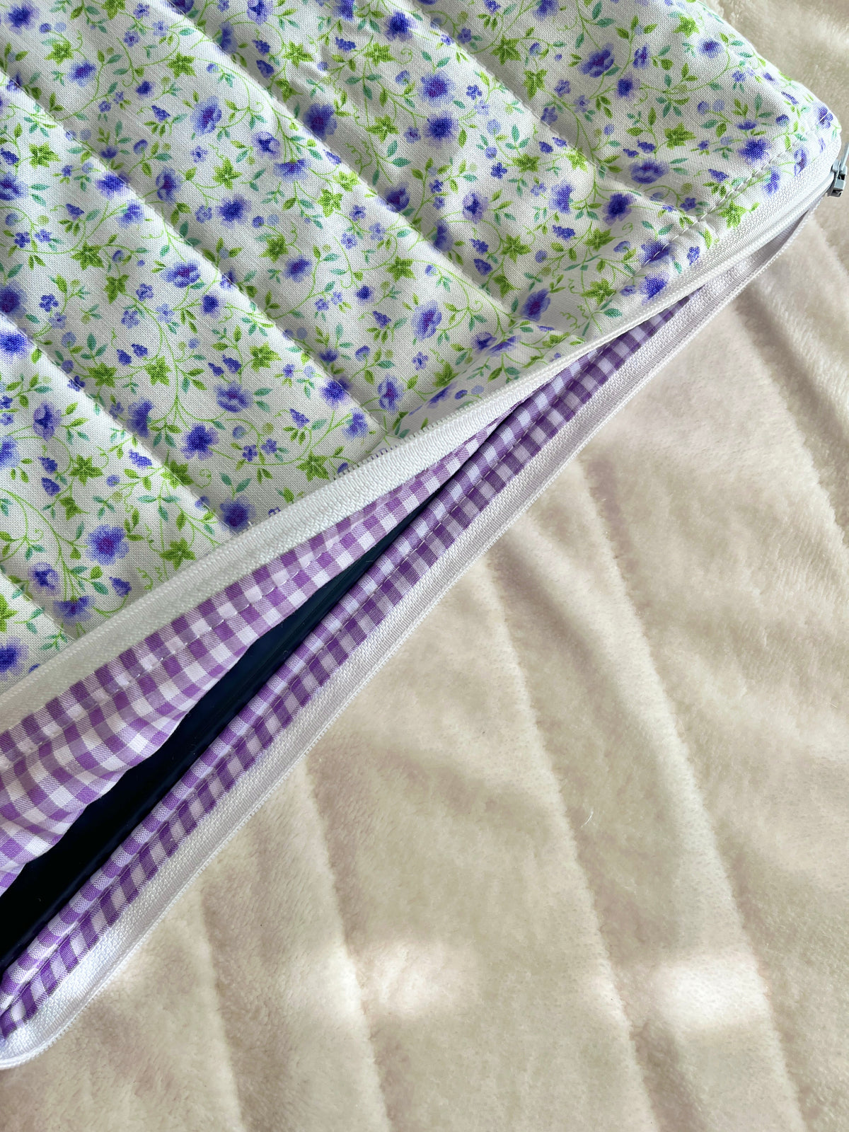 Laptop sleeve interior view with purple gingham lining and zipper trim