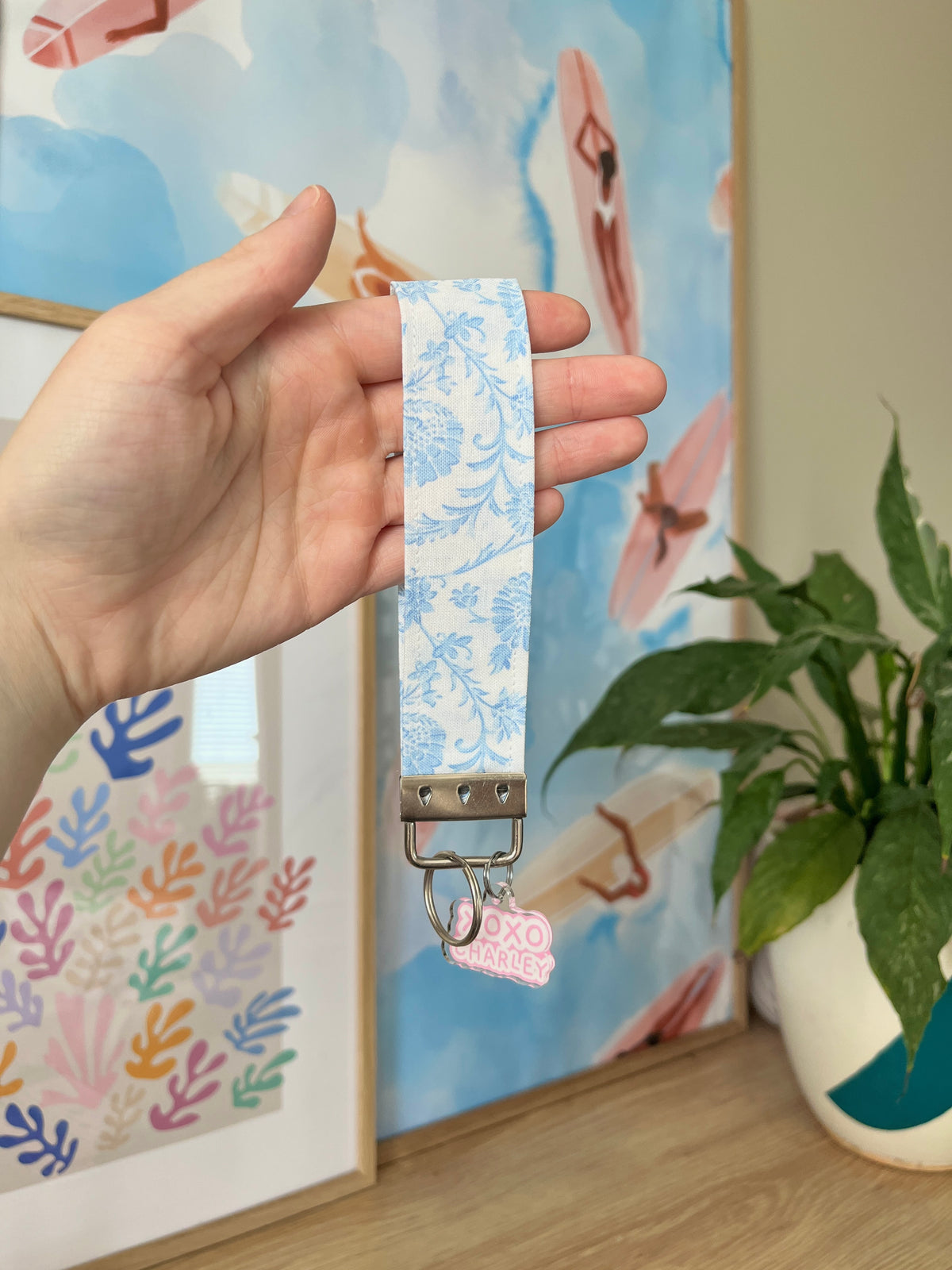 Blue vintage keychain wristlet with metal clip and small charm