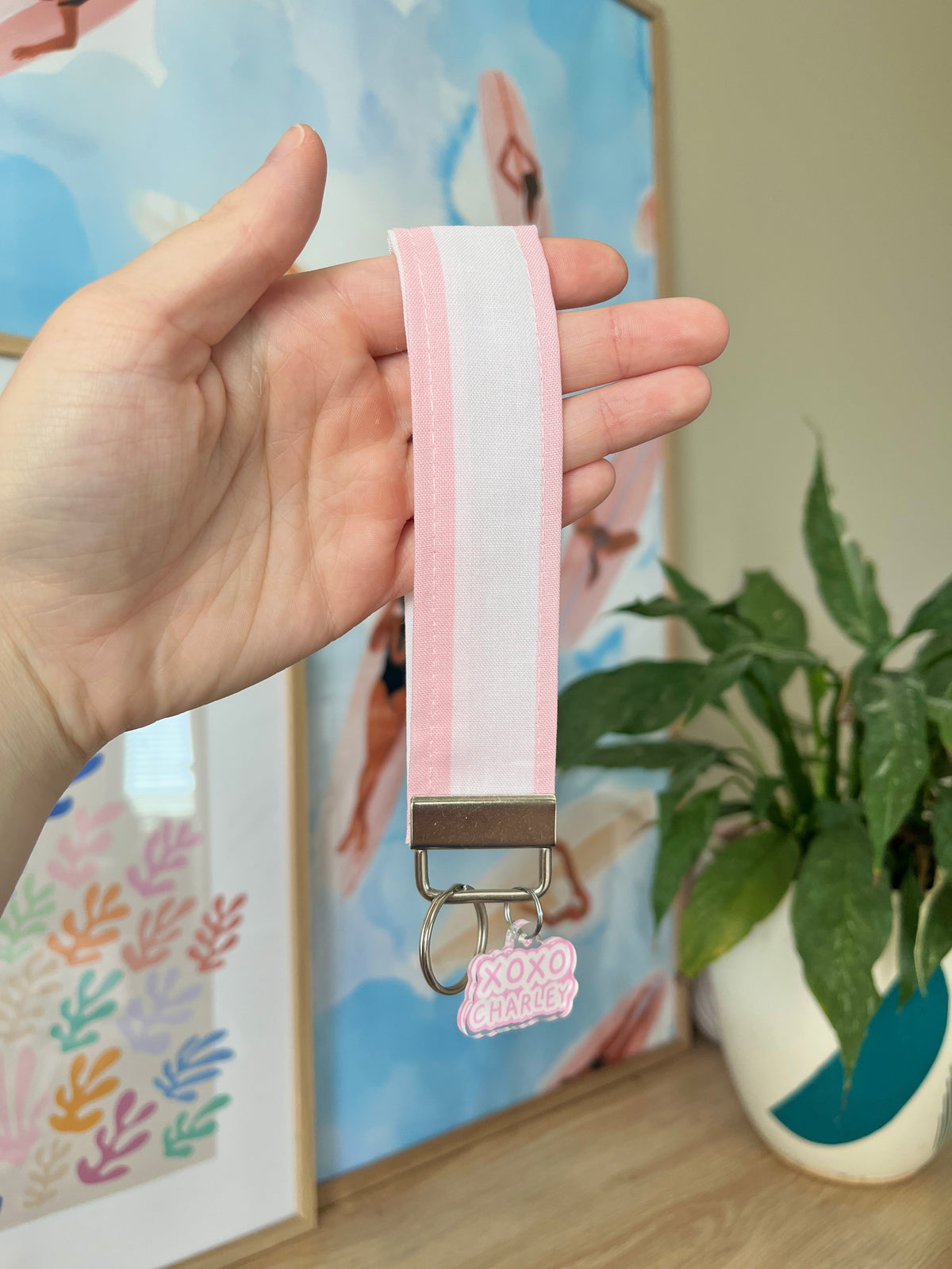 Pink and white striped wristlet strap with silver key ring and lobster clip