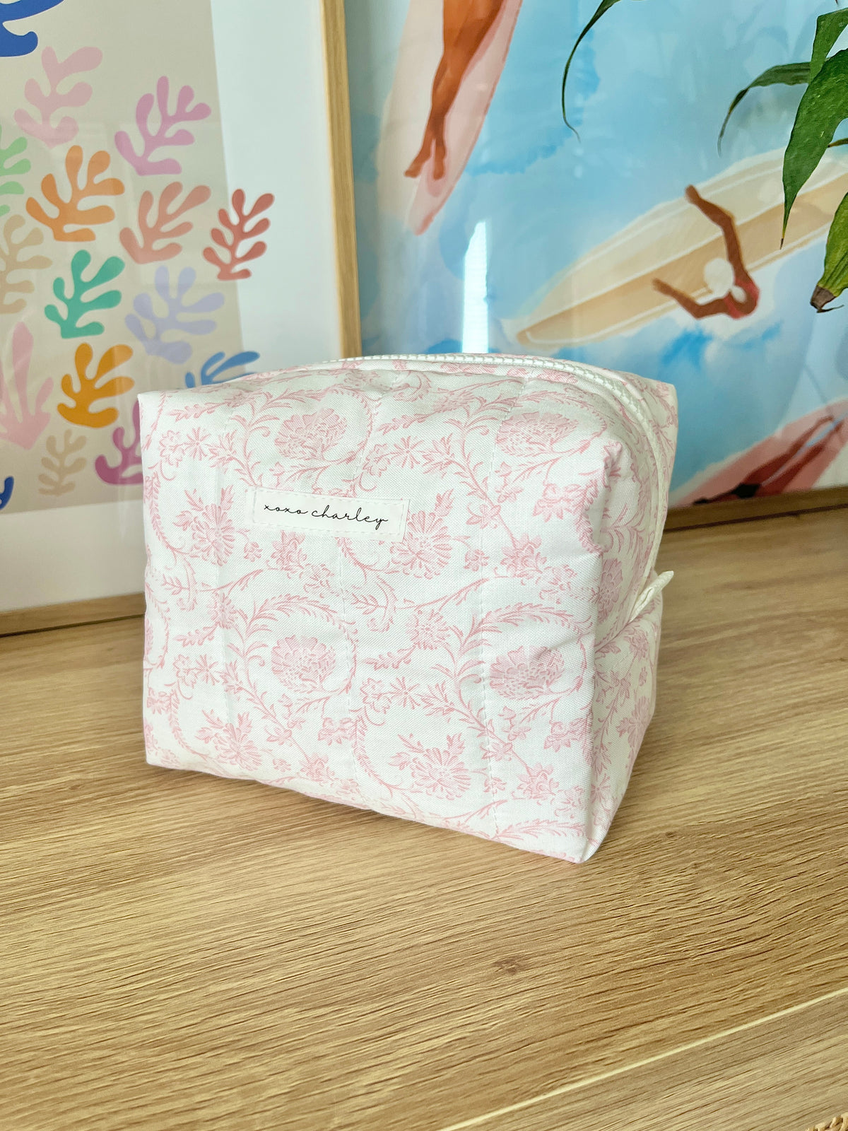 Pink floral medium makeup bag, front view with zipper closure