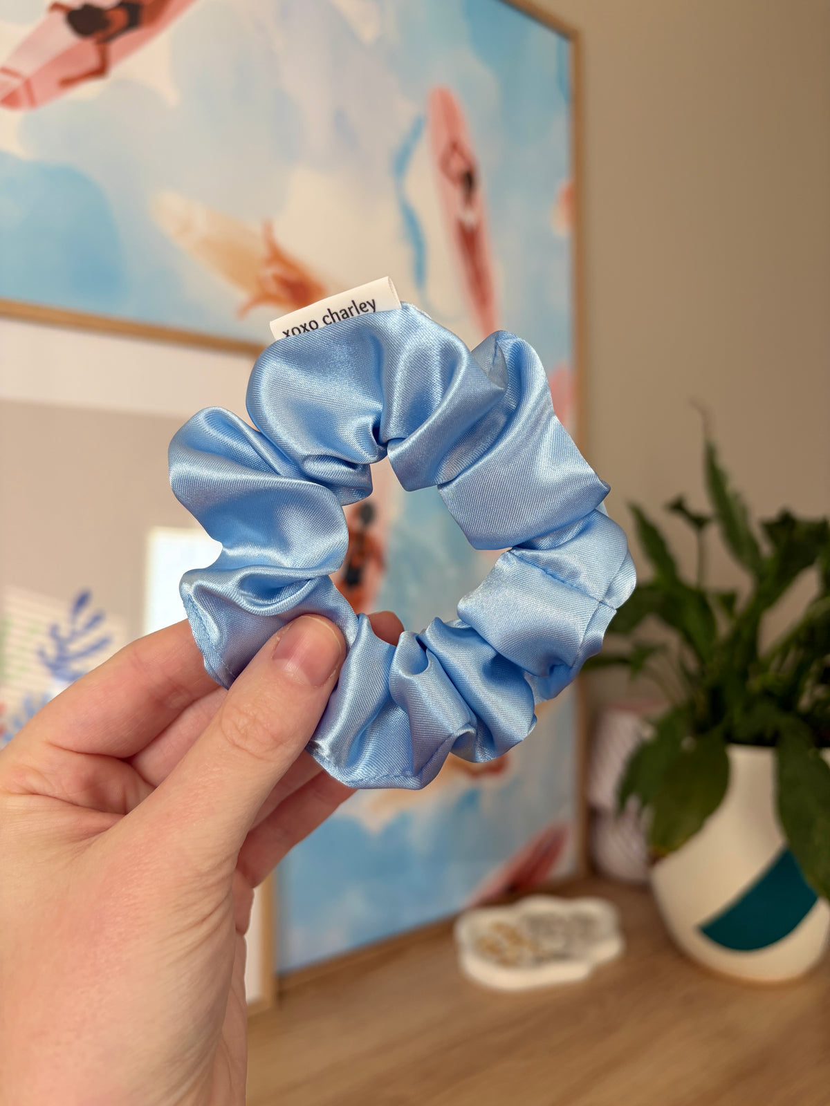 Light blue satin scrunchie with gathered ruffled fabric