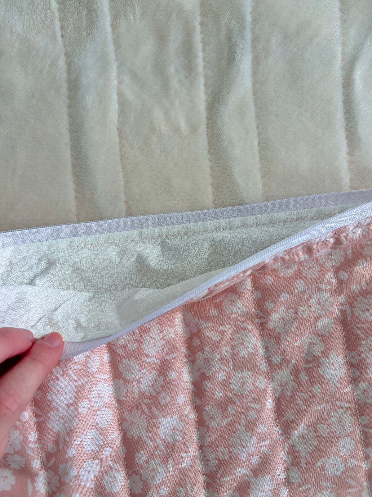 Blush floral sleeve with light blue zipper opening and quilted white lining