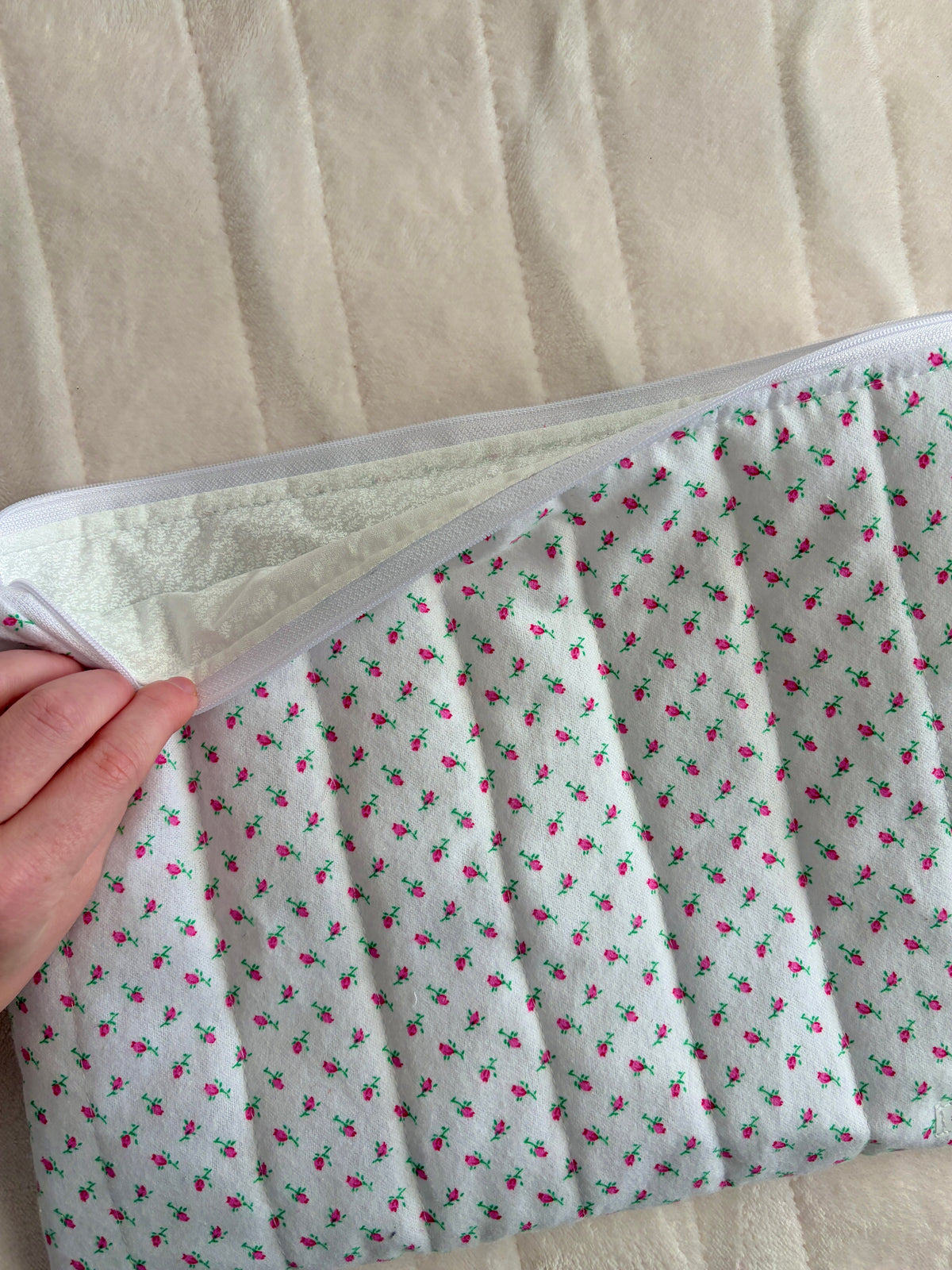 Laptop and tablet sleeve with zipper open, showing light inner lining