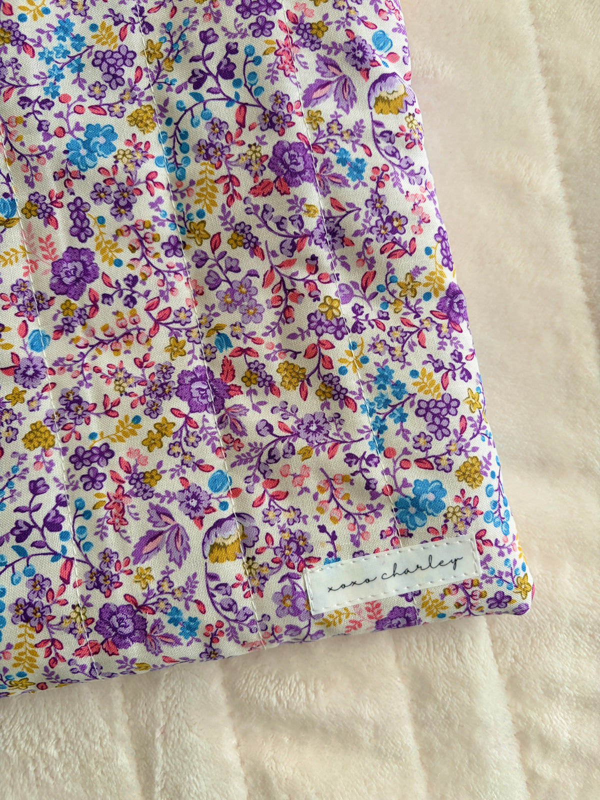 Floral laptop & tablet sleeve detail, purple and blue ditsy pattern with zip edge