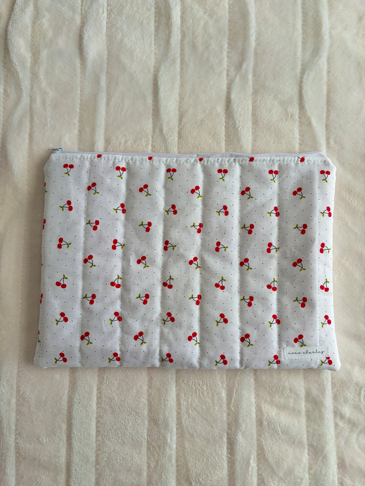 Laptop and tablet sleeve, light gray fabric with red cherry pattern, padded exterior