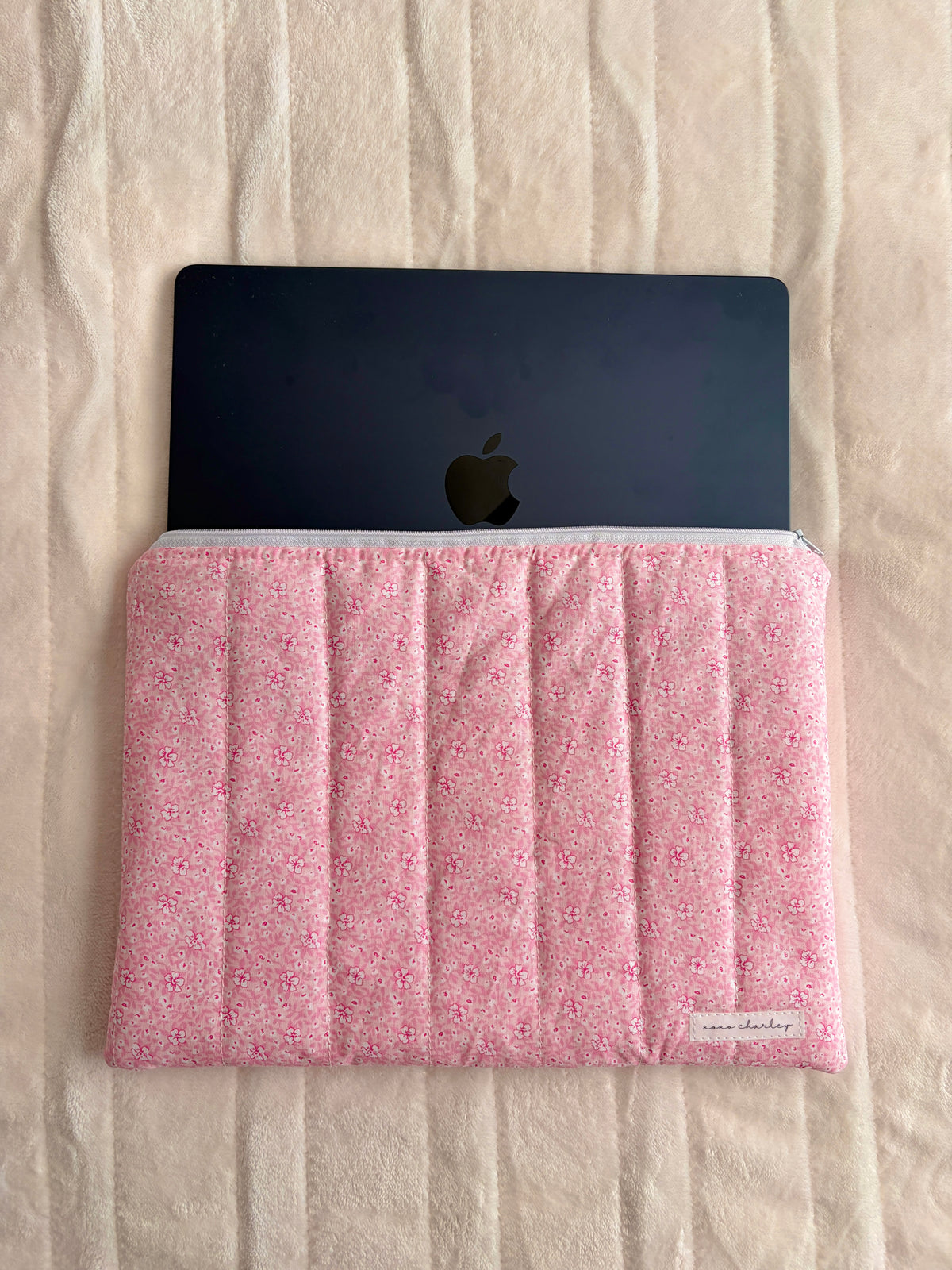 Pink floral laptop sleeve with laptop inside and padded front flap