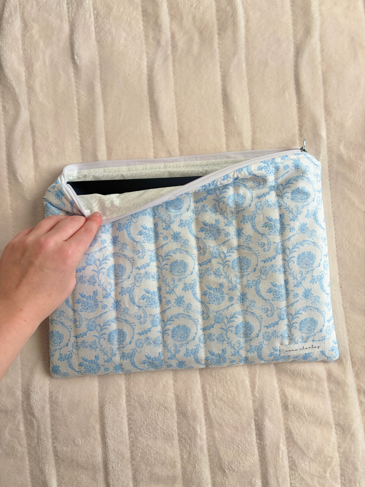 Blue floral laptop and tablet sleeve with carry handle and zipper top
