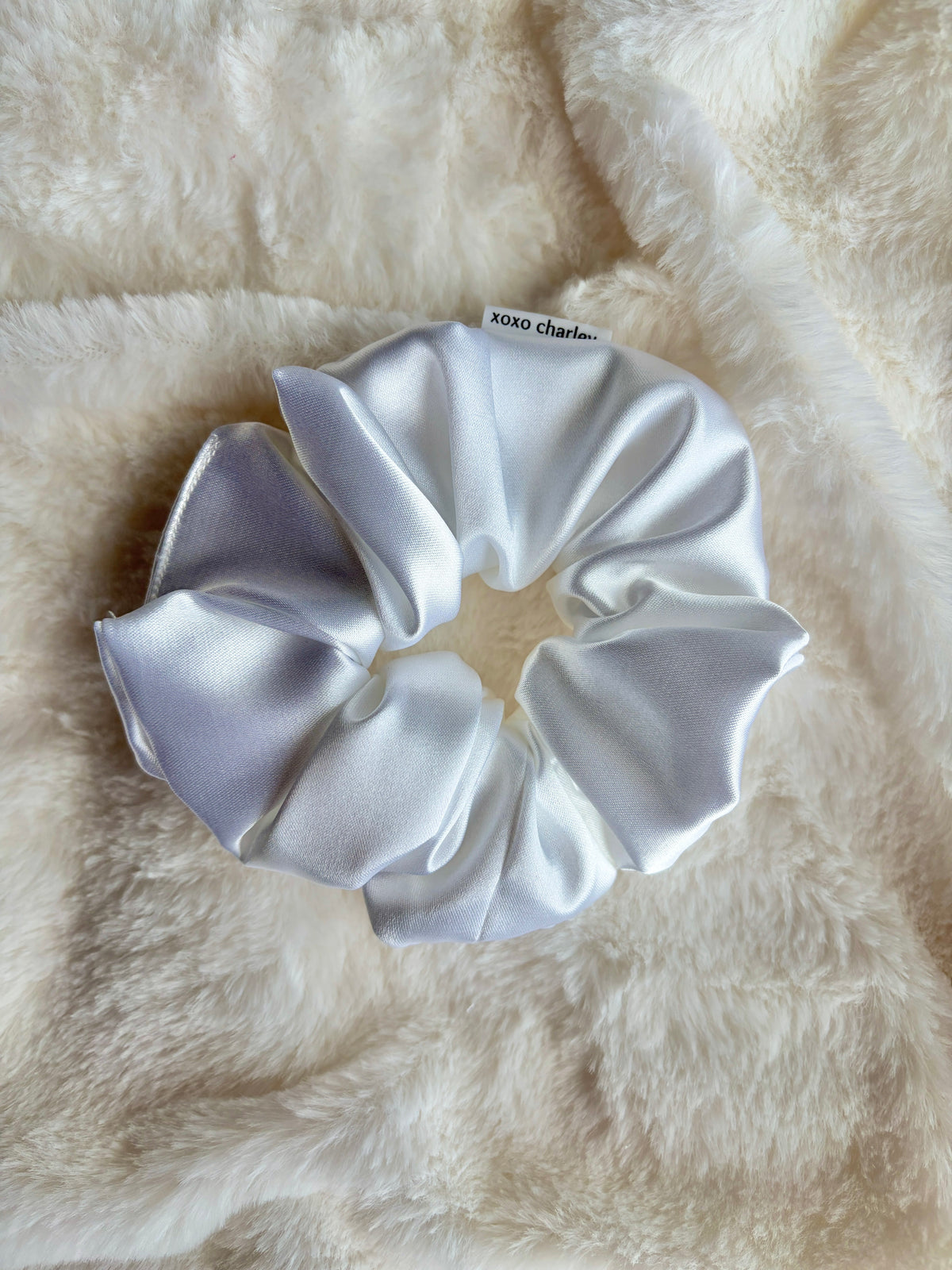 Large satin scrunchie in light silver satin with gathered, ruched texture